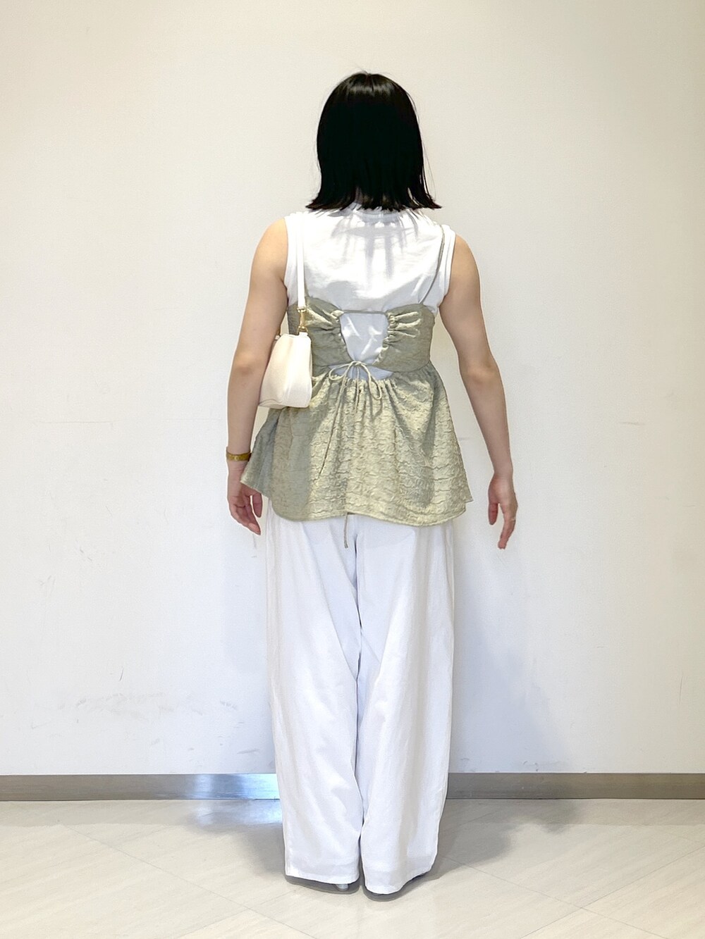 ホワイト系のその他パンツ、グリーン系のTシャツ/カットソー、ホワイト系のショルダーバッグを着用したレディースの夏コーディネートの4枚目の写真