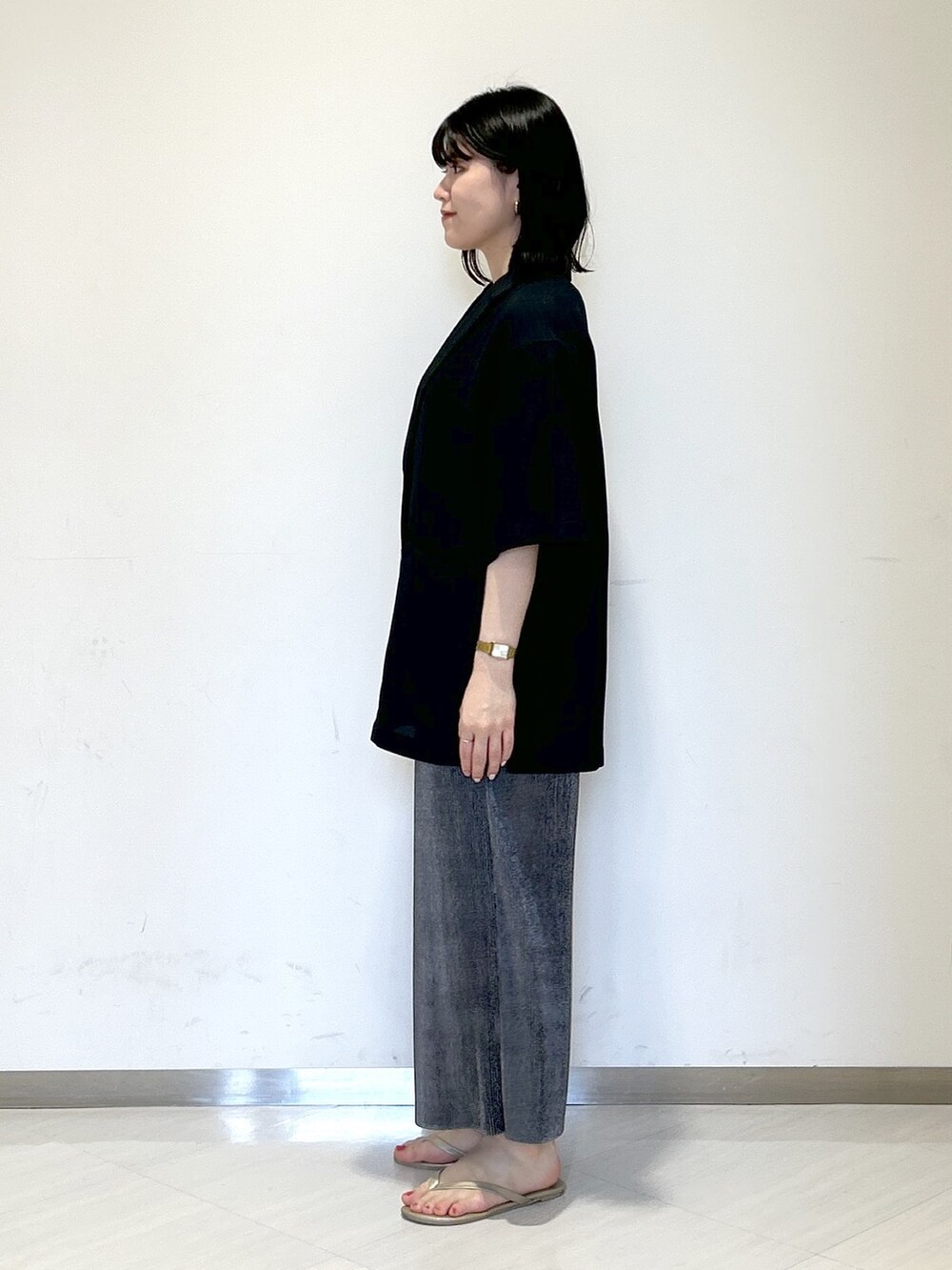 ブラック系のタンクトップ、ホワイト系のショルダーバッグ、ブラック系のテーラードジャケットを着用したレディースの夏コーディネートの2枚目の写真