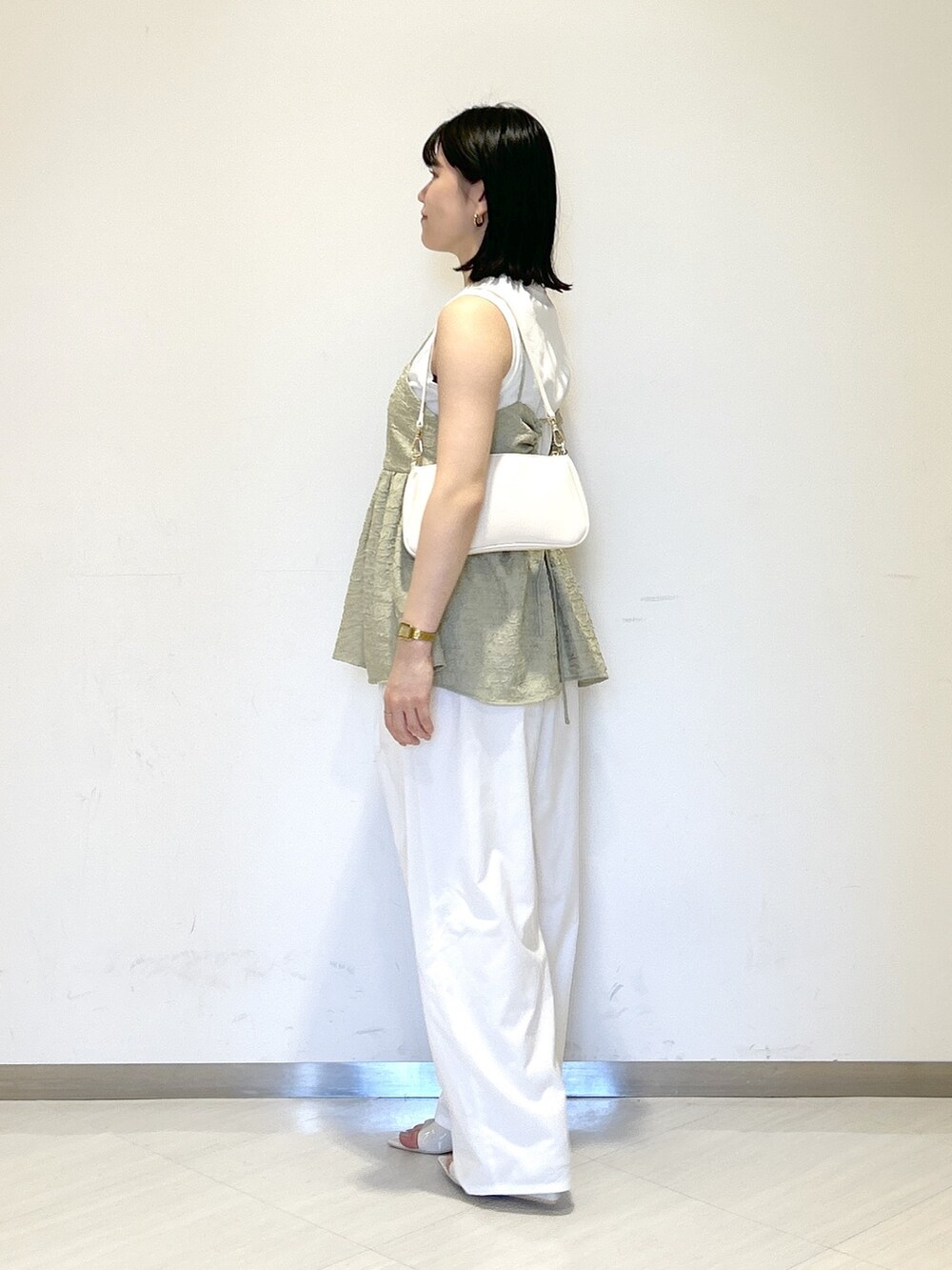 ホワイト系のその他パンツ、グリーン系のTシャツ/カットソー、ホワイト系のショルダーバッグを着用したレディースの夏コーディネートの3枚目の写真
