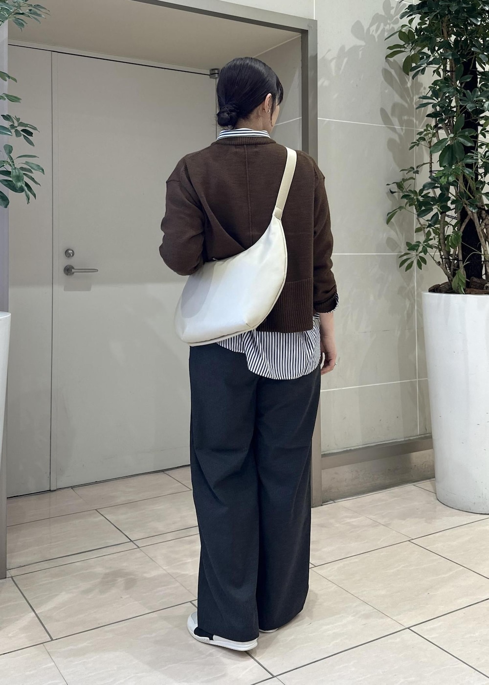 グレー系のその他パンツ、ブルー系のシャツ/ブラウス、ホワイト系のスニーカーを着用したレディースの冬コーディネートの4枚目の写真