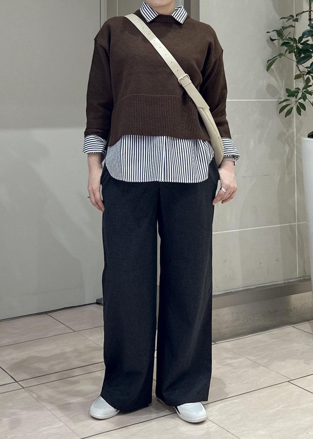 グレー系のその他パンツ、ブルー系のシャツ/ブラウス、ホワイト系のスニーカーを着用したレディースの冬コーディネートの5枚目の写真