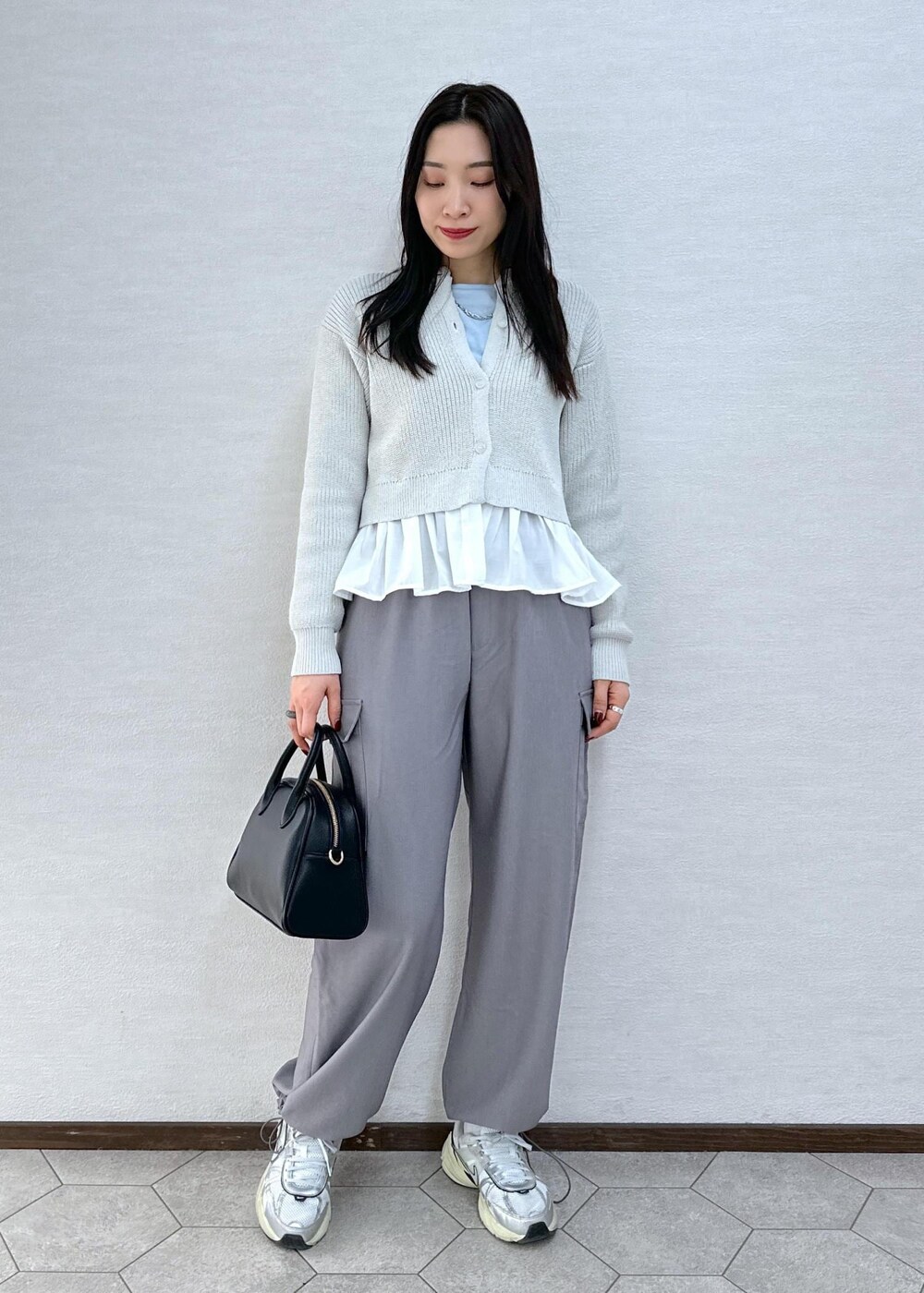 グレー系のカーゴパンツ、ブルー系のTシャツ/カットソー、グレー系のカーディガン/ボレロを着用したレディースの冬コーディネートの2枚目の写真