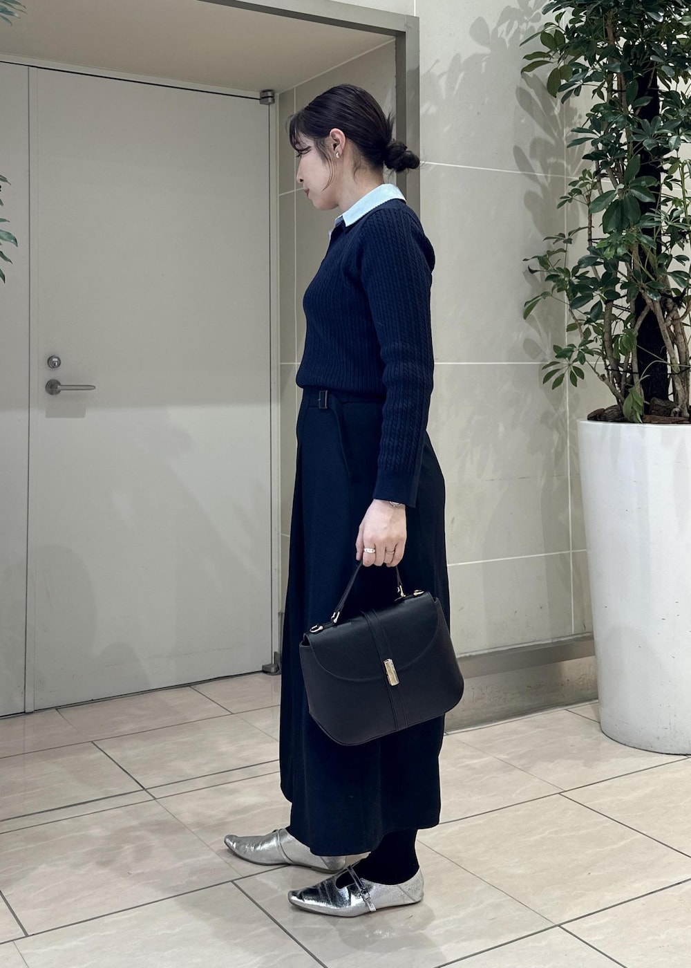ブルー系のスカート、ブルー系のニット/セーター、ブラック系のショルダーバッグを着用したレディースの冬コーディネートの3枚目の写真