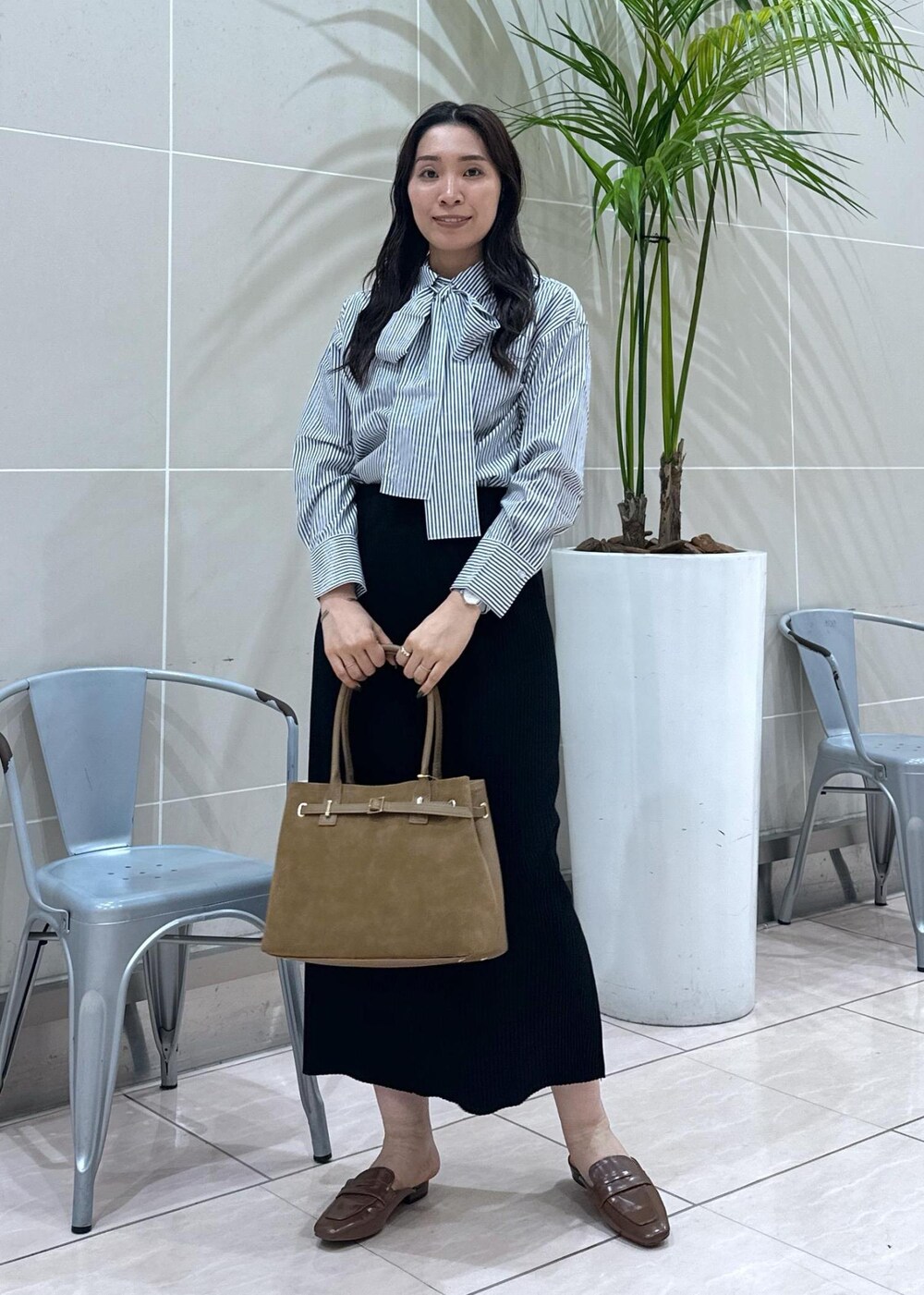 イエロー系のローファー、イエロー系のトートバッグ、ブルー系のシャツ/ブラウスを着用したレディースの秋コーディネートの2枚目の写真