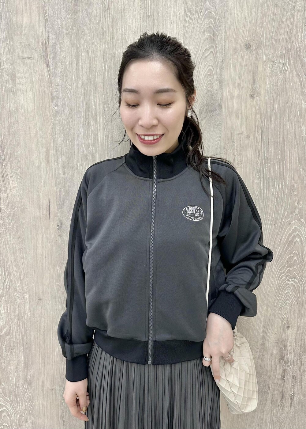 グレー系のワンピース、ピンク系のショルダーバッグ、グレー系のその他アウターを着用したレディースの冬コーディネートの3枚目の写真