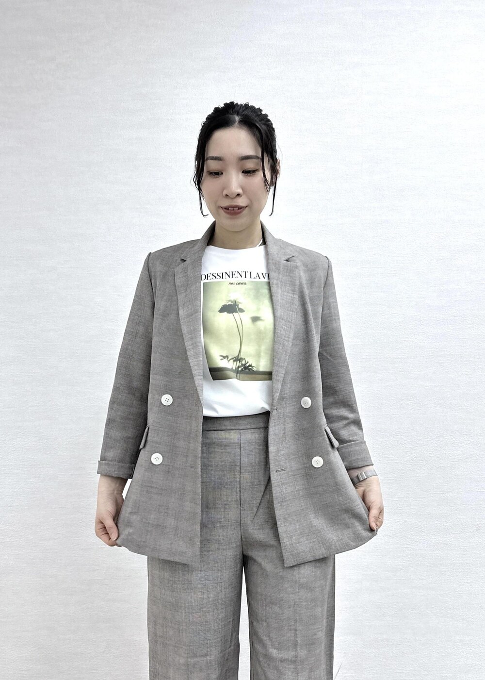 ベージュ系のテーラードジャケット、ベージュ系のスラックス、ホワイト系のTシャツ/カットソーを着用したレディースの春コーディネートの6枚目の写真