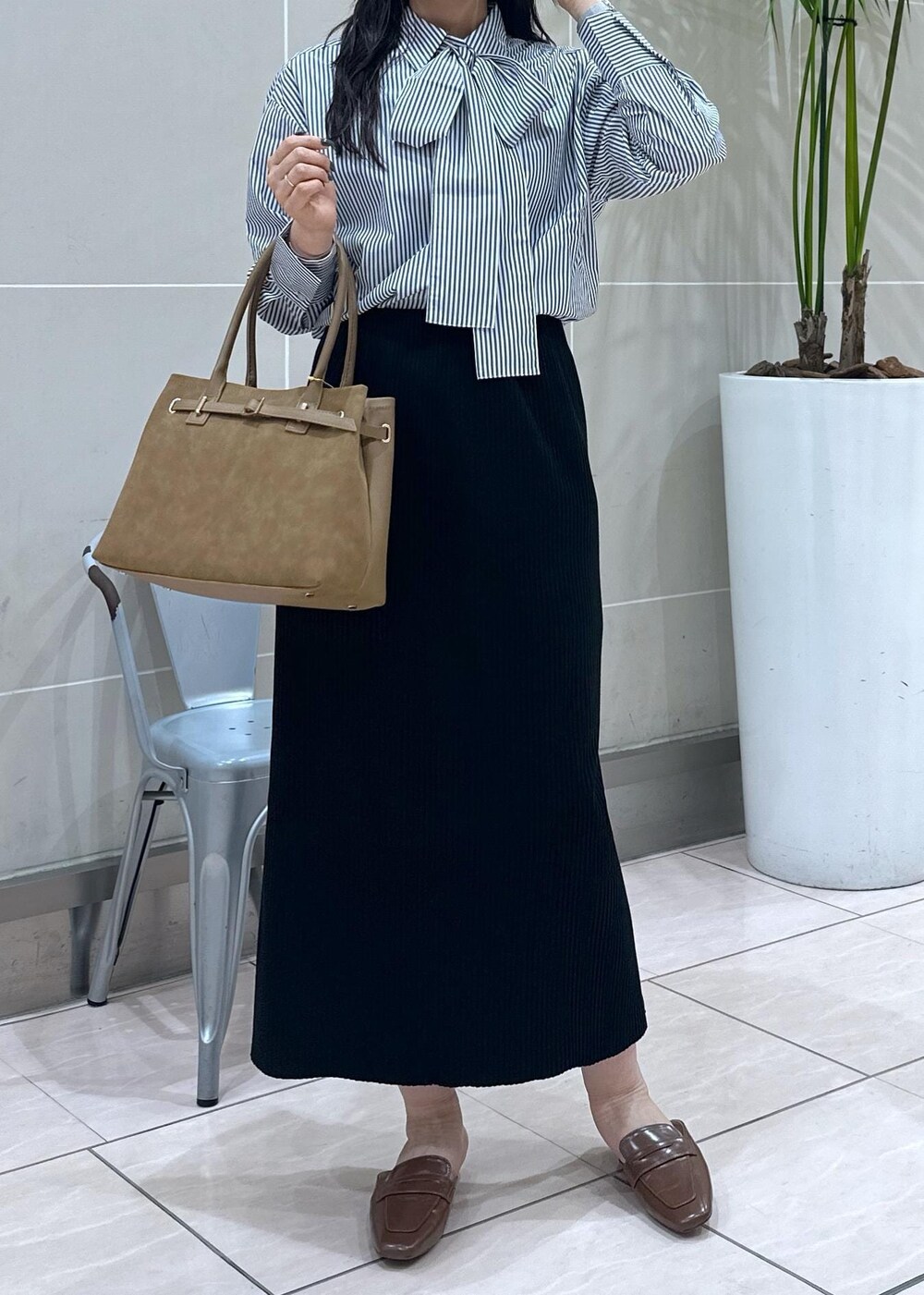 イエロー系のローファー、イエロー系のトートバッグ、ブルー系のシャツ/ブラウスを着用したレディースの秋コーディネートの6枚目の写真