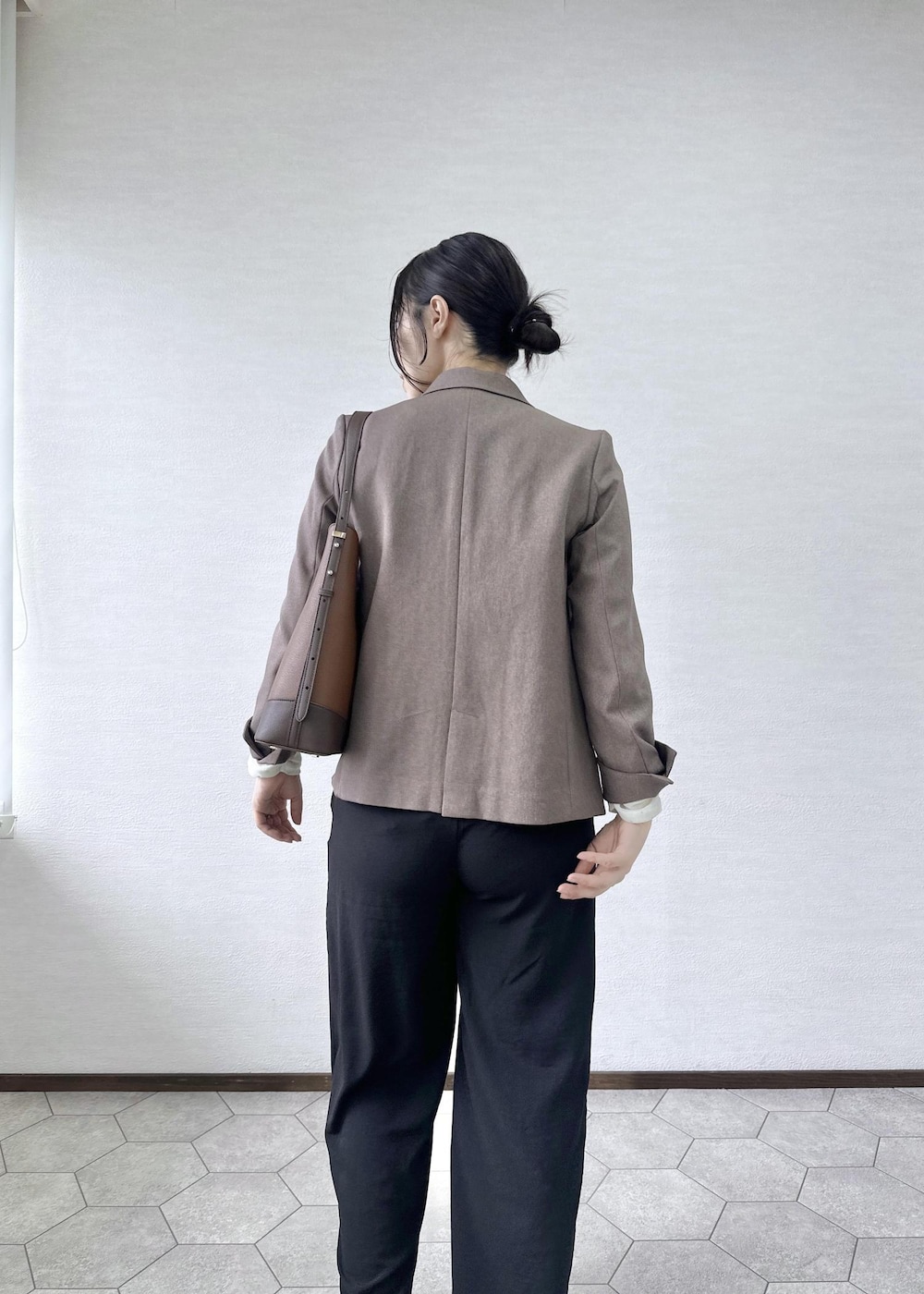 ブラック系のその他パンツ、ホワイト系のTシャツ/カットソー、ベージュ系のテーラードジャケットを着用したレディースの秋コーディネートの5枚目の写真