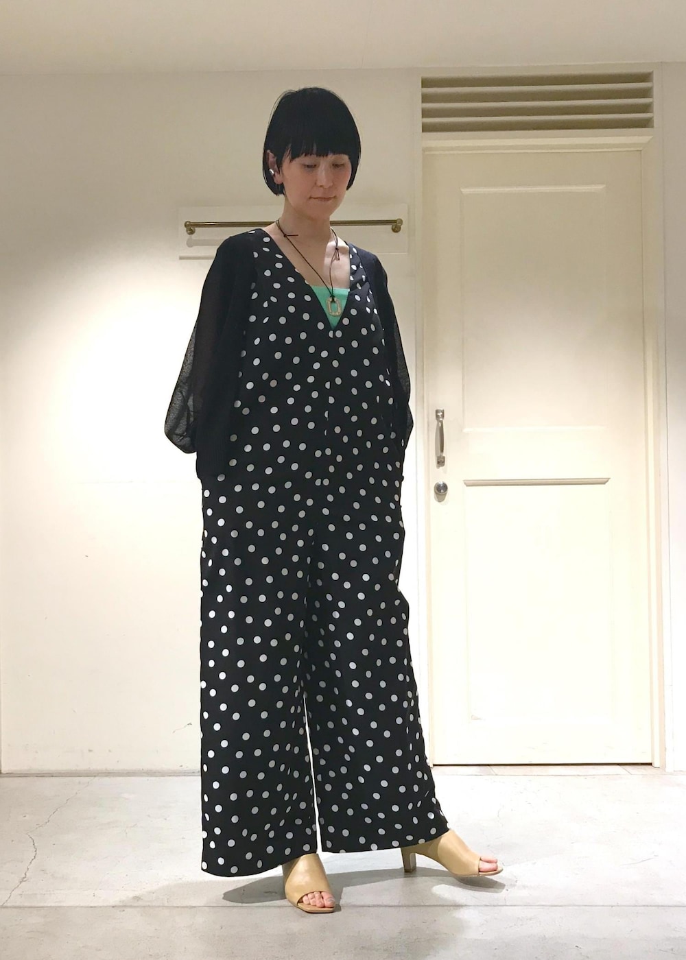 ホワイト系のサンダル、グリーン系のチューブトップ、ブラック系のカーディガン/ボレロを着用したレディースの夏コーディネートの2枚目の写真