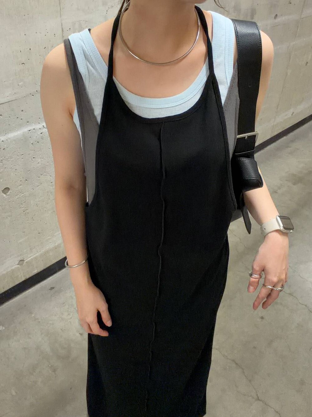 ブルー系のタンクトップ、ブラック系のワンピース、ブラック系のショルダーバッグを着用したレディースの夏コーディネートの5枚目の写真