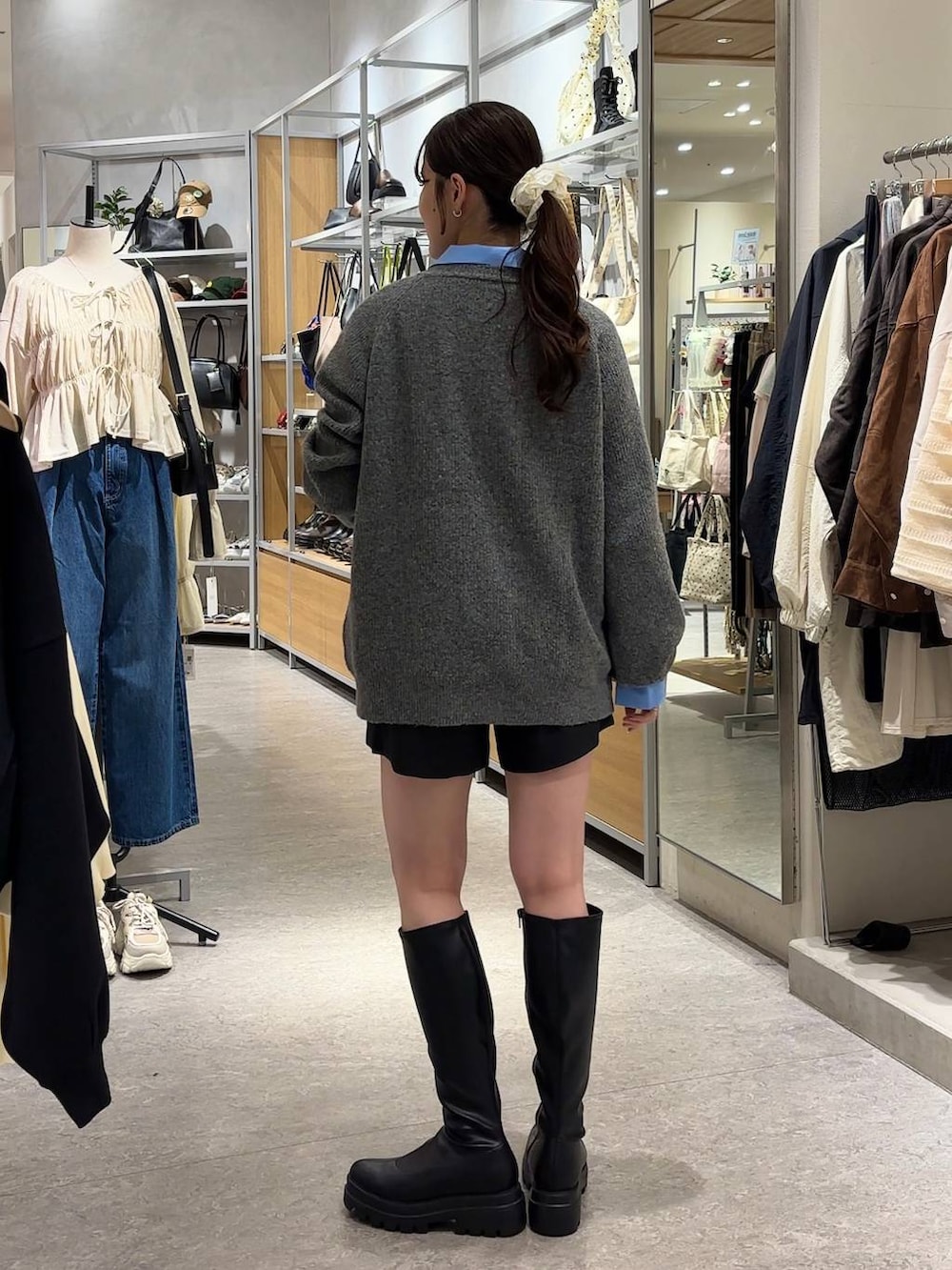 グレー系のその他パンツ、ブルー系のシャツ/ブラウス、ブラック系のブーツを着用したレディースの秋コーディネートの2枚目の写真