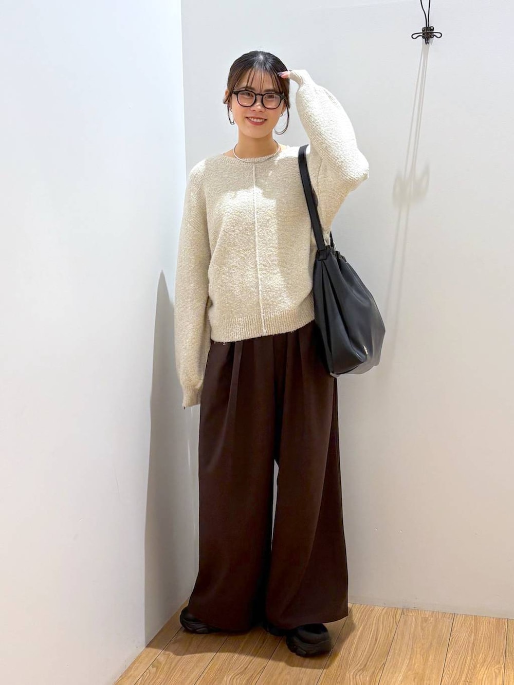 ブラック系のブーツ、ブラック系のショルダーバッグ、ブラウン系のその他パンツを着用したレディースの冬コーディネートの2枚目の写真