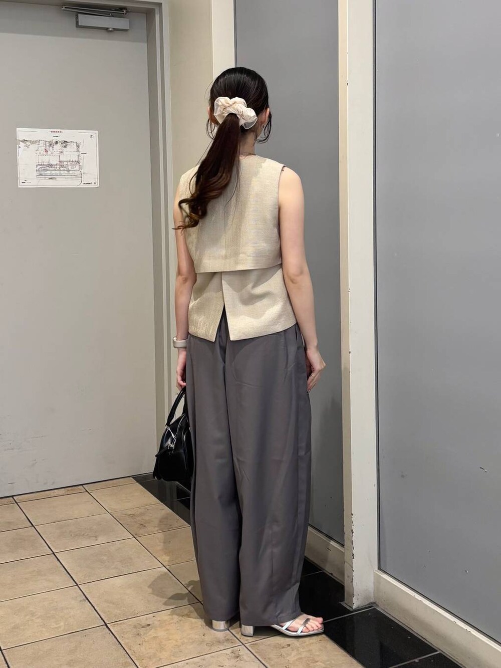 ベージュ系のブルゾン、シルバー系のサンダル、グレー系のその他パンツを着用したレディースの夏コーディネートの3枚目の写真