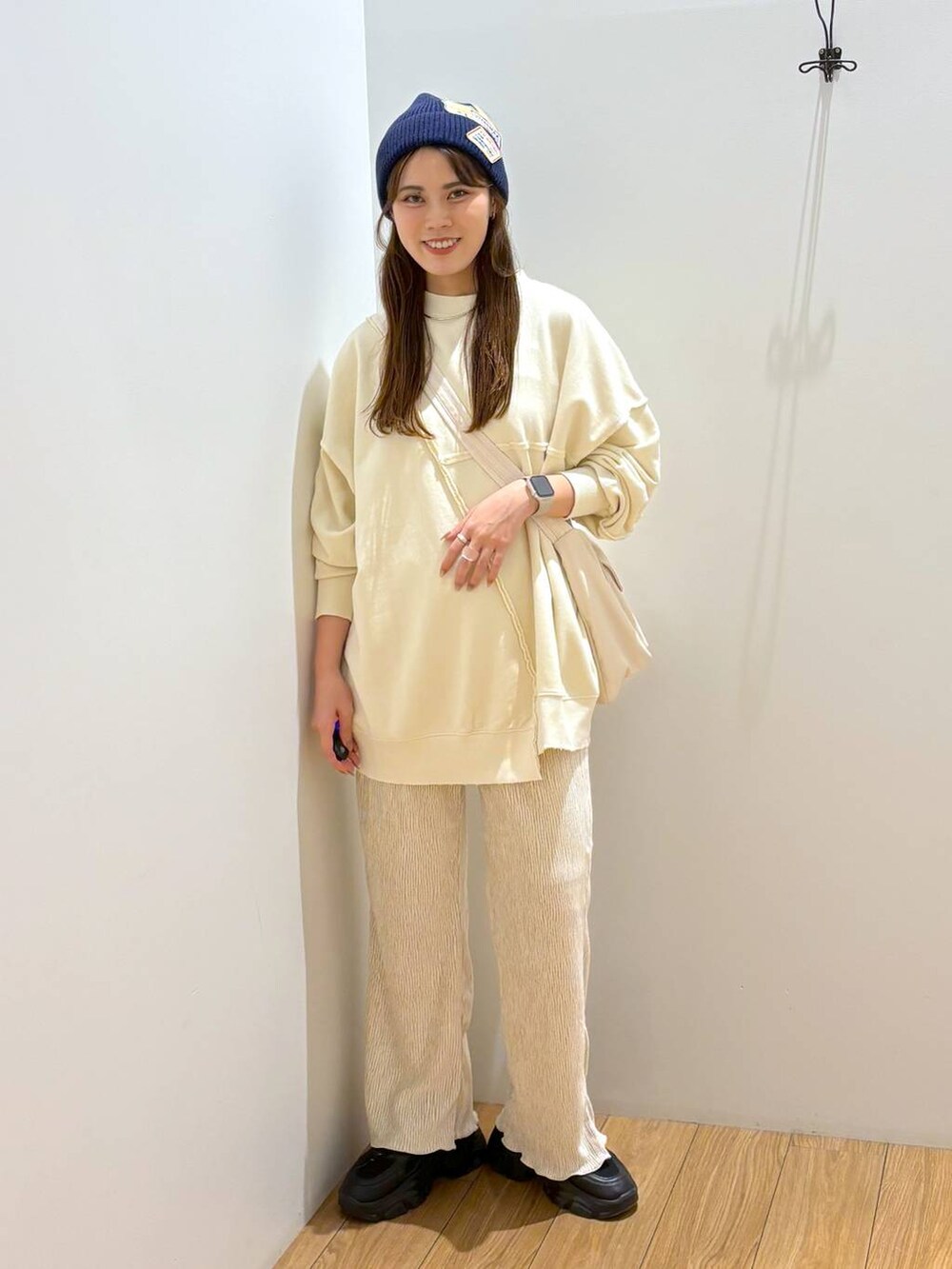 ホワイト系のその他パンツ、ブラック系のスニーカー、ホワイト系のショルダーバッグを着用したレディースの冬コーディネートの5枚目の写真