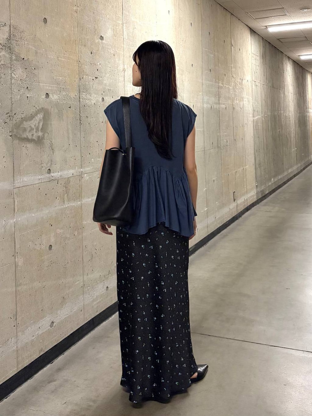 ブルー系のTシャツ/カットソー、ブラック系のスカート、ブラック系のトートバッグを着用したレディースの夏コーディネートの3枚目の写真