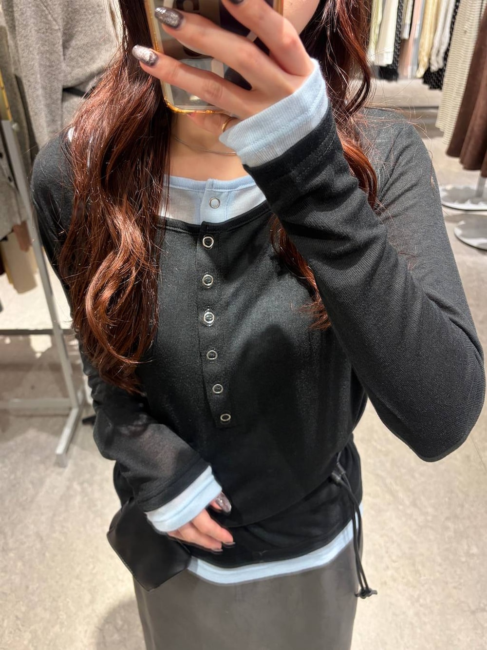 グレー系のTシャツ/カットソー、ブラック系のスカートを着用したレディースの秋コーディネートの3枚目の写真