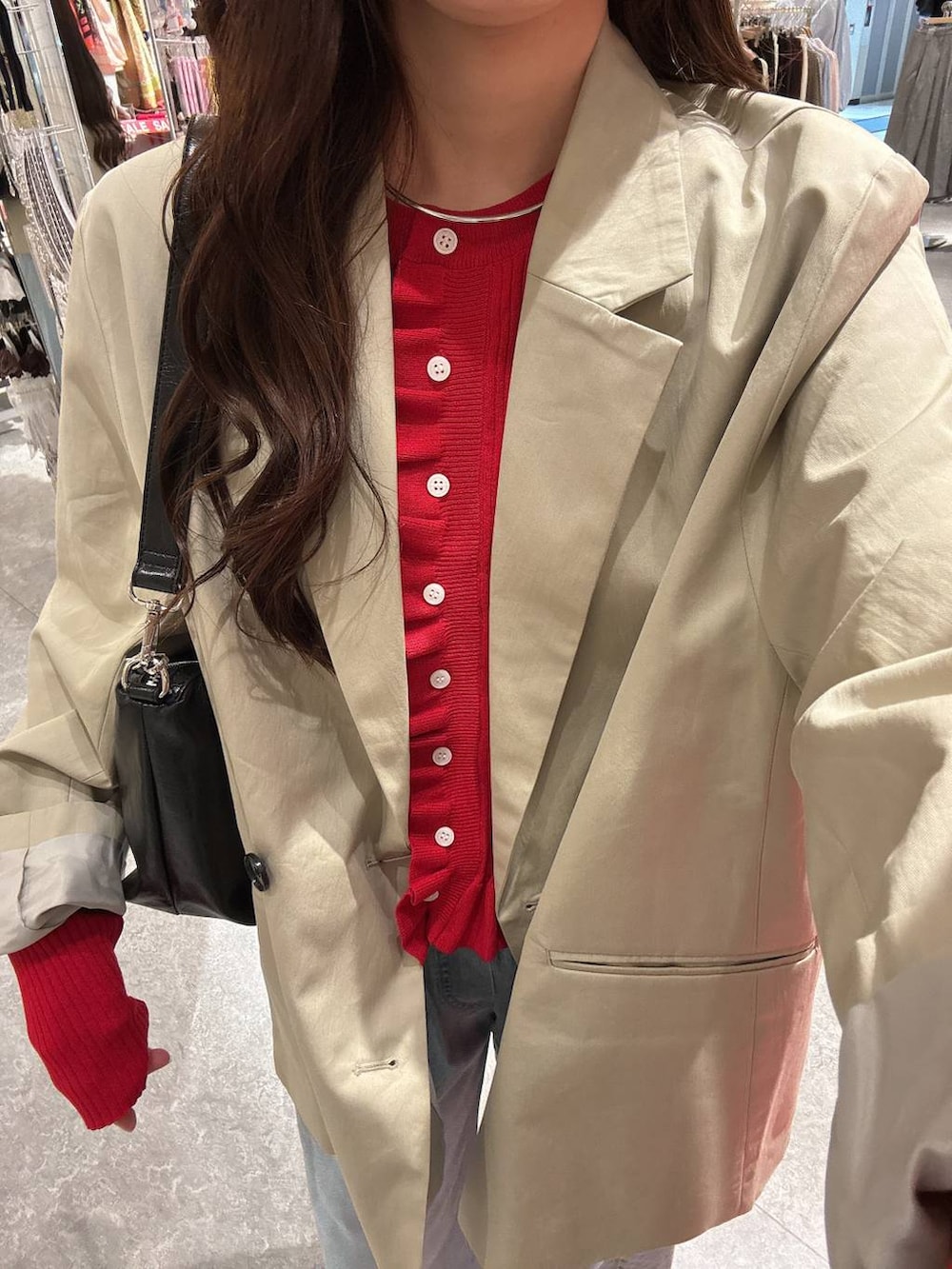 ブラック系のローファー、ブルー系のデニムパンツ、ブラック系のショルダーバッグを着用したレディースの冬コーディネートの5枚目の写真