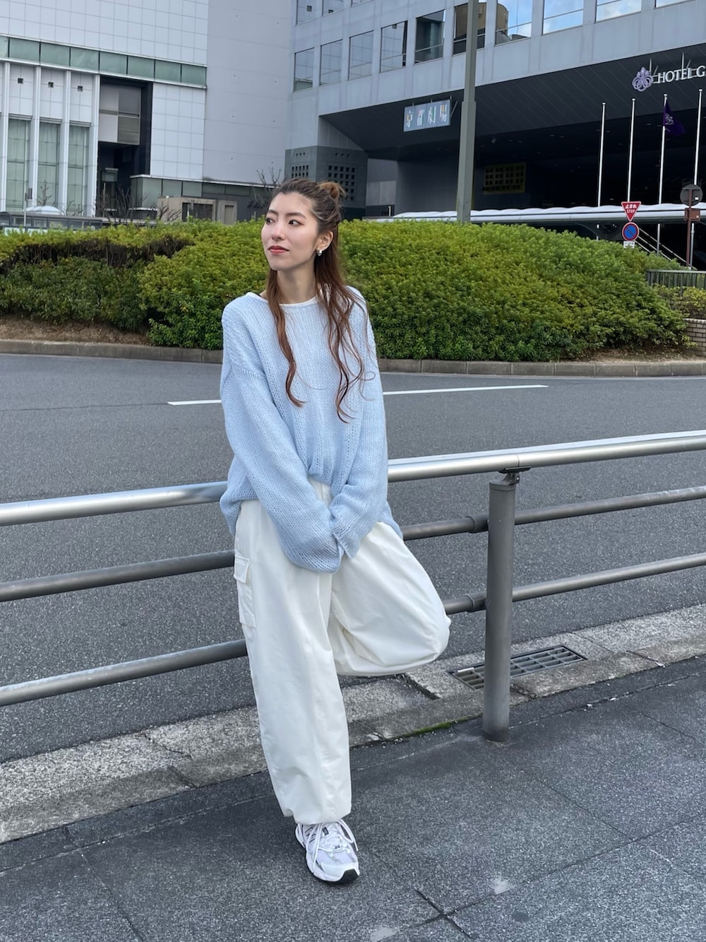 ブルー系のニット/セーター、ホワイト系のTシャツ/カットソー、ホワイト系のカーゴパンツを着用したレディースの冬コーディネートの2枚目の写真