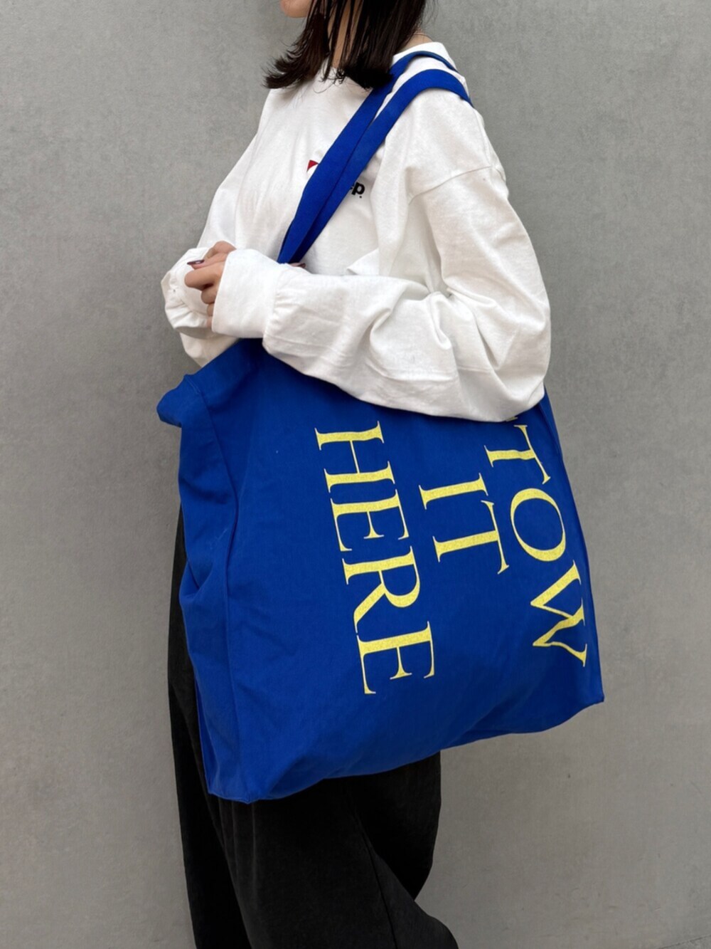 グレー系のその他パンツ、ブルー系のトートバッグ、ホワイト系のTシャツ/カットソーを着用したレディースの秋コーディネートの6枚目の写真