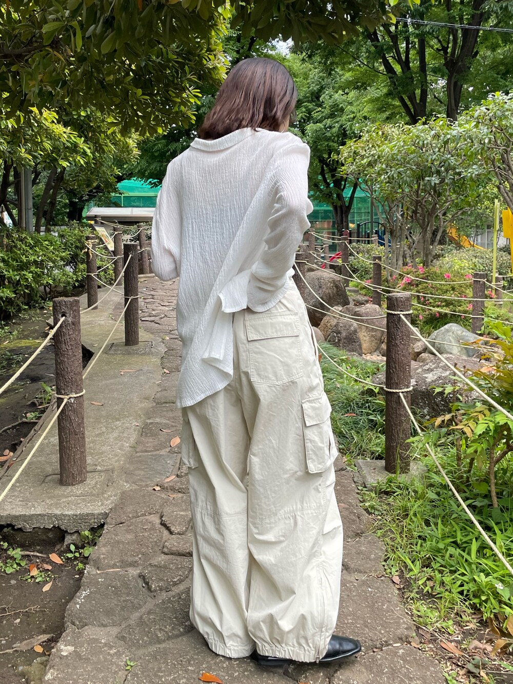 ブラック系のキャミソール、ホワイト系のシャツ/ブラウス、ホワイト系のカーゴパンツを着用したレディースの夏コーディネートの3枚目の写真