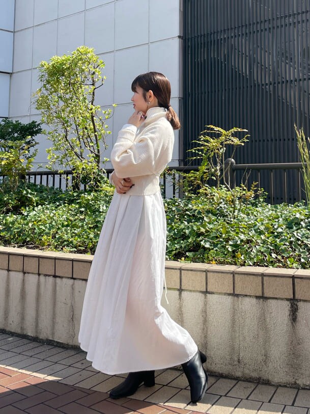 ブラック系のブーツ、ホワイト系のワンピースを着用したレディースの秋コーディネートの5枚目の写真