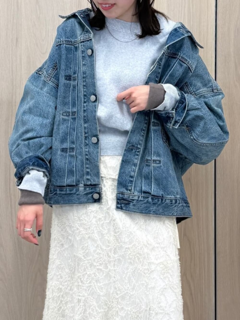 ホワイト系のスカート、ブルー系のデニムジャケット、グレー系のニット/セーターを着用したレディースの冬コーディネートの5枚目の写真