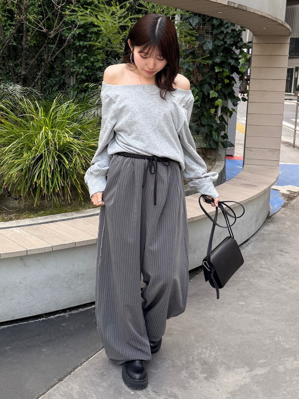 グレー系のTシャツ/カットソー、ブラック系のハンドバッグ、グレー系のその他パンツを着用したレディースの冬コーディネートの6枚目の写真