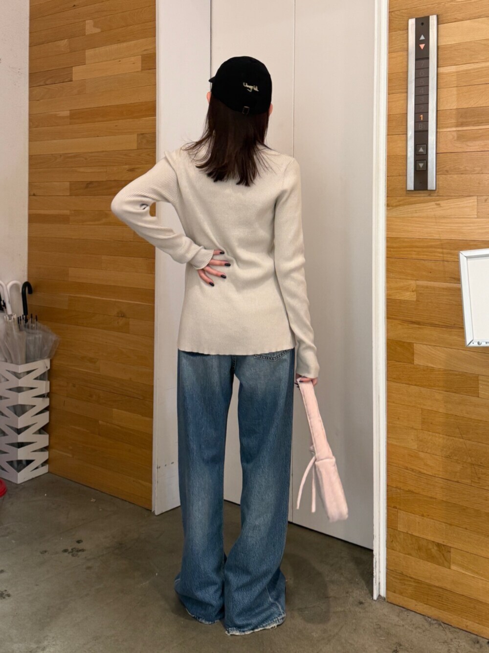 ブラウン系のブーツ、ブルー系のデニムパンツ、ピンク系のハンドバッグを着用したレディースの秋コーディネートの6枚目の写真