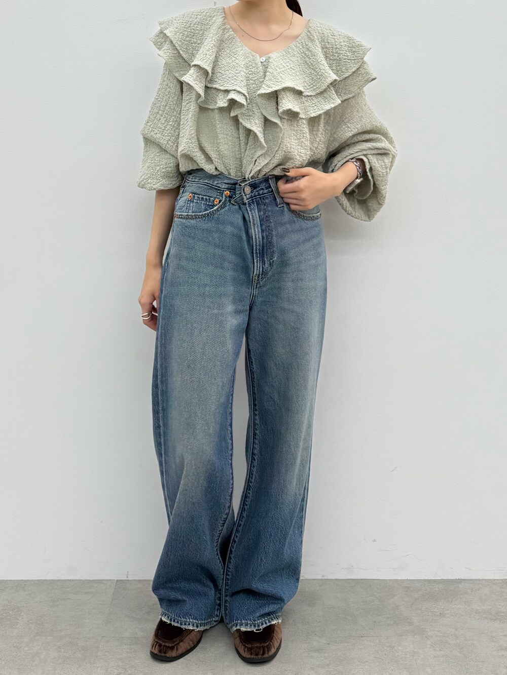 ブルー系のデニムパンツ、ブラウン系のローファー、ブルー系のシャツ/ブラウスを着用したレディースの秋コーディネートの2枚目の写真