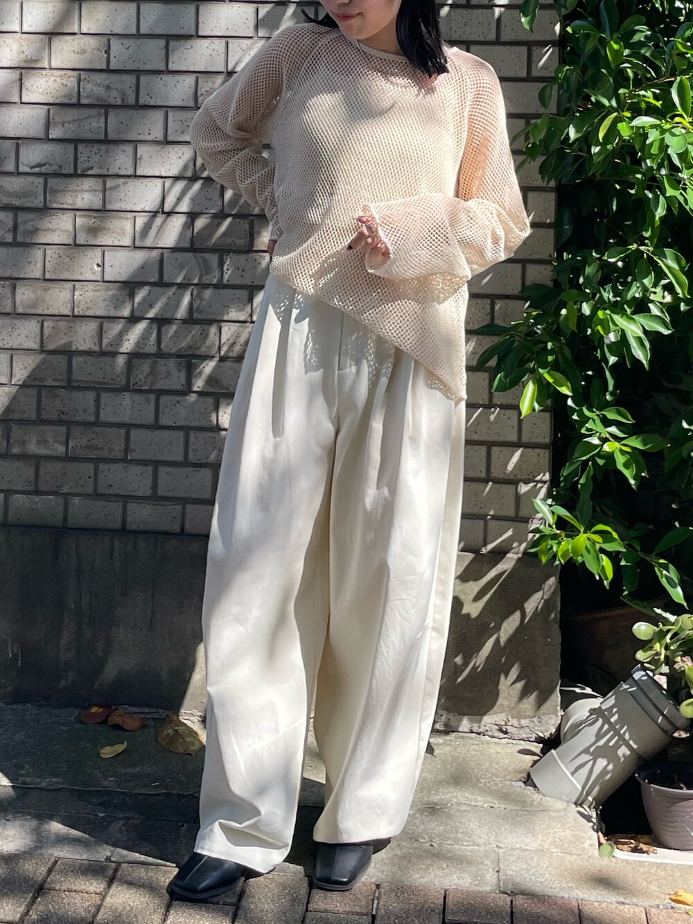 ブラック系のブーツ、ホワイト系のチノパンツ、ホワイト系のTシャツ/カットソーを着用したレディースの冬コーディネートの5枚目の写真