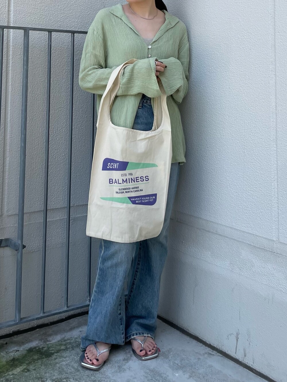 グリーン系のシャツ/ブラウス、グレー系のキャミソール、ホワイト系のエコバッグ/サブバッグを着用したレディースの夏コーディネートの3枚目の写真