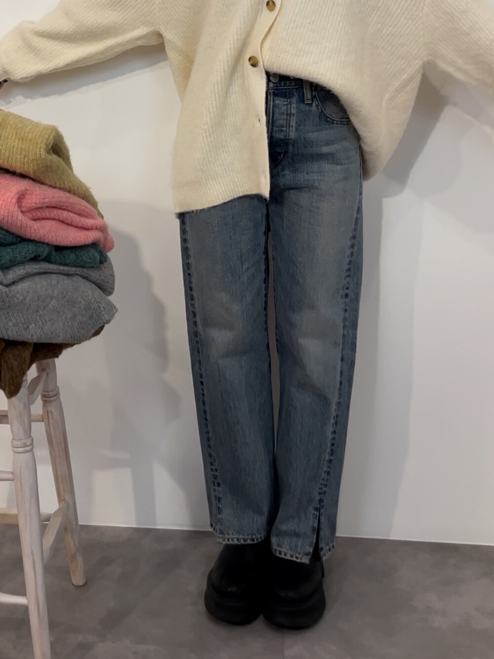 ブルー系のデニムパンツ、ブラック系のブーツ、ホワイト系のカーディガン/ボレロを着用したレディースの冬コーディネートの6枚目の写真