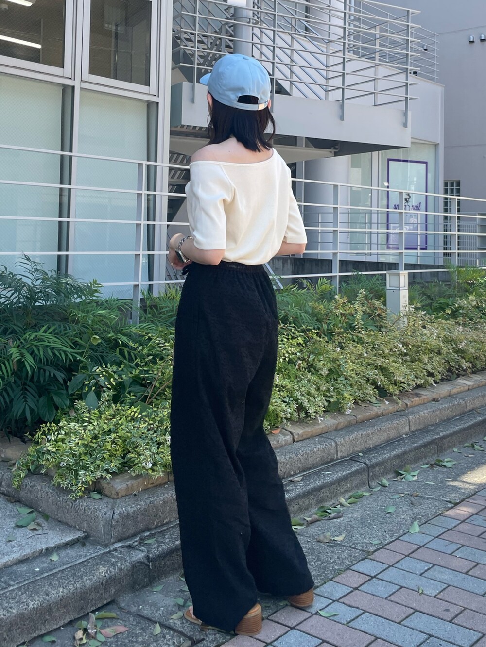 ホワイト系のサンダル、ブラック系のその他パンツ、ホワイト系のTシャツ/カットソーを着用したレディースの夏コーディネートの6枚目の写真