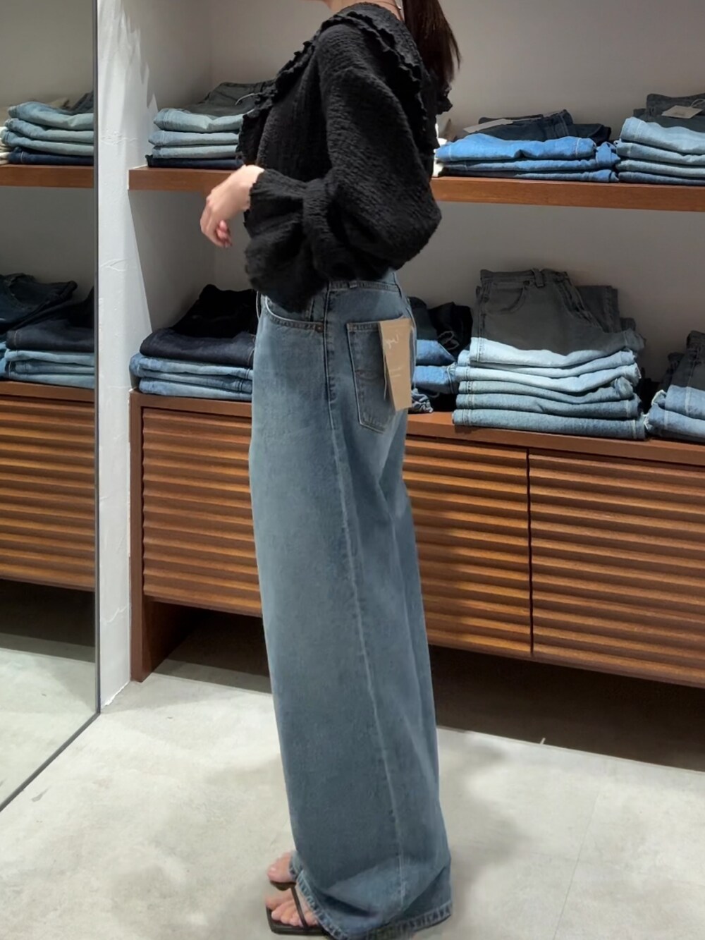 ブラック系のシャツ/ブラウス、ブルー系のデニムパンツを着用したレディースの春コーディネートの3枚目の写真