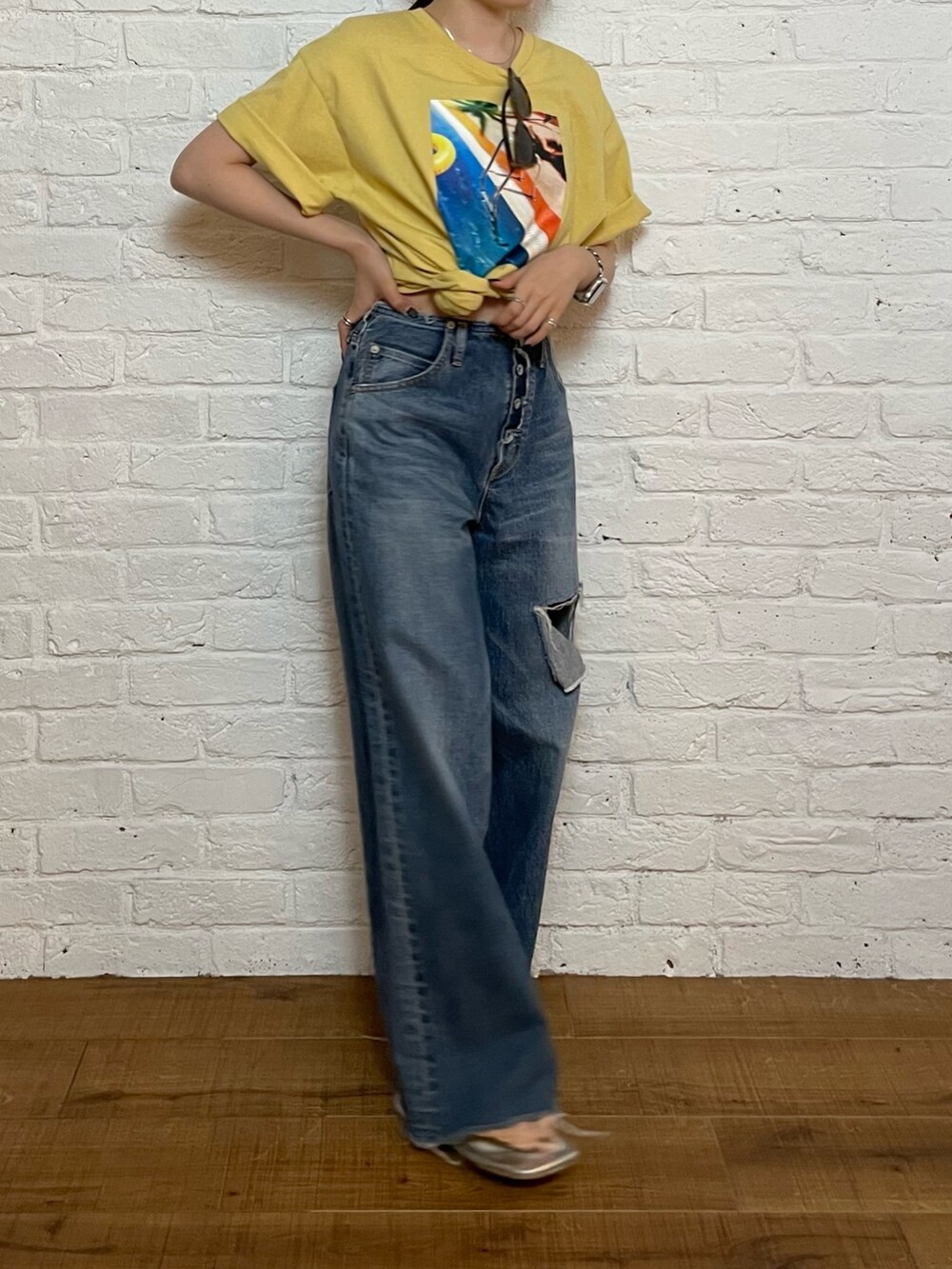 シルバー系のサンダル、ブルー系のデニムパンツ、イエロー系のTシャツ/カットソーを着用したレディースの夏コーディネートの3枚目の写真