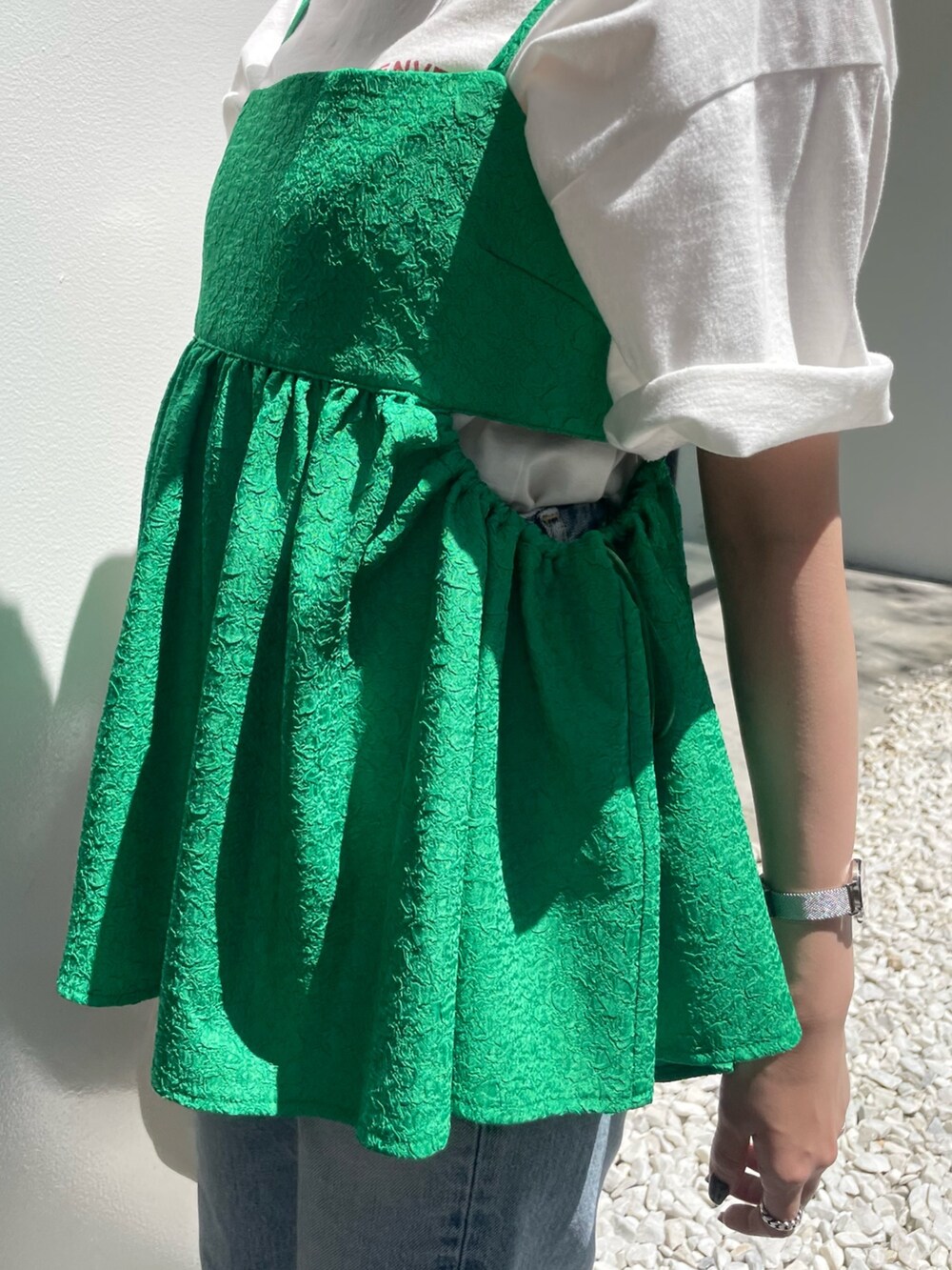 ホワイト系のハンドバッグ、ブルー系のデニムパンツ、グリーン系のシャツ/ブラウスを着用したレディースの春コーディネートの7枚目の写真