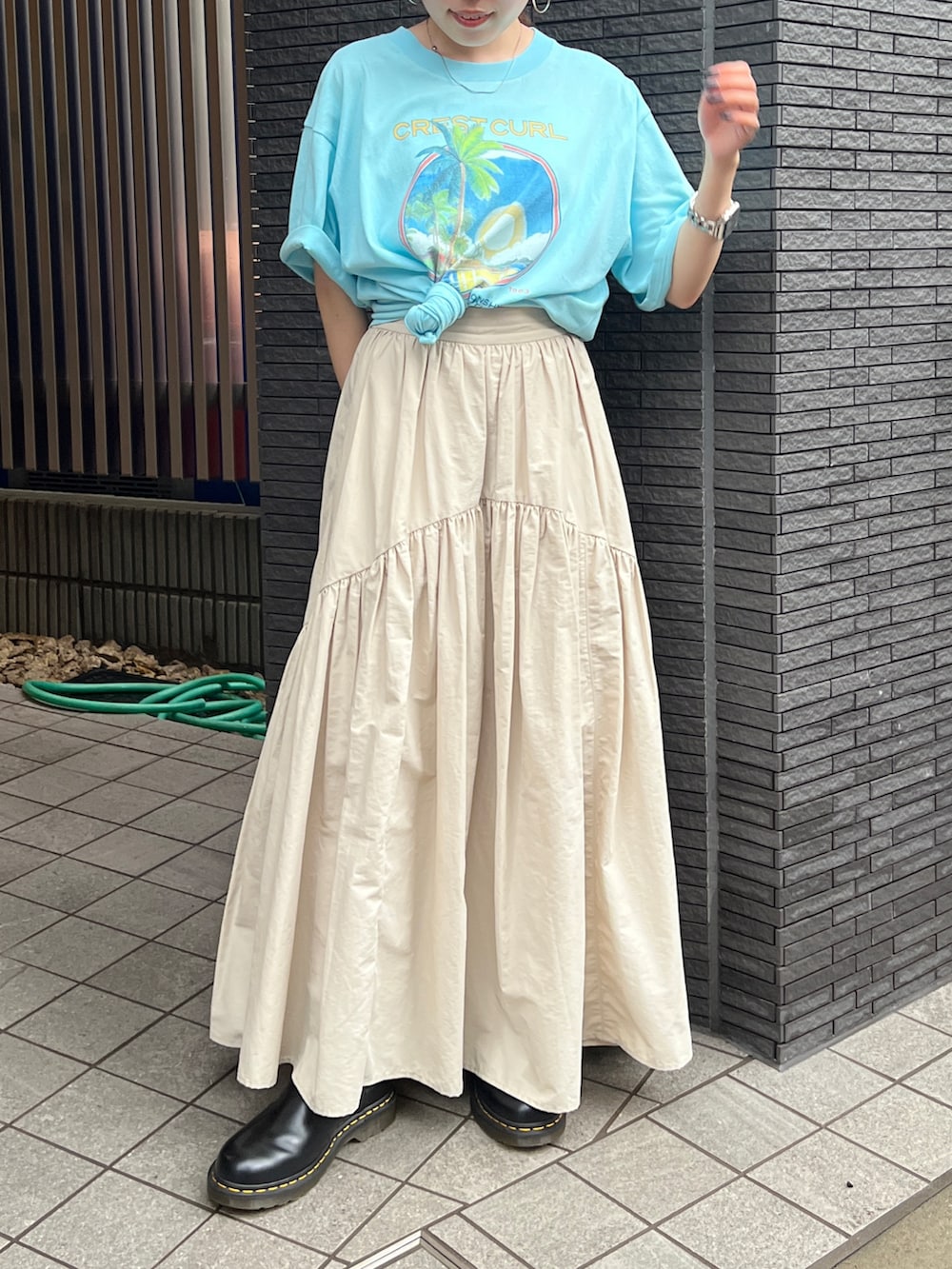 ホワイト系のスカート、ブラック系のブーツ、ブルー系のデニムジャケットを着用したレディースの春コーディネートの8枚目の写真