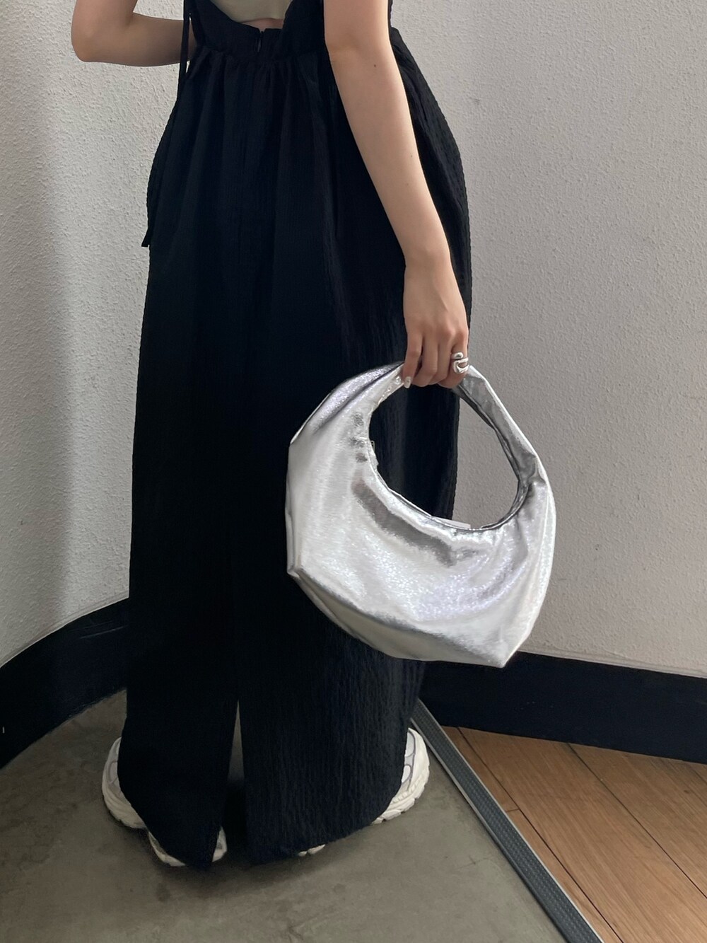 グレー系のキャミソール、シルバー系のハンドバッグ、ブラック系のワンピースを着用したレディースの春コーディネートの8枚目の写真