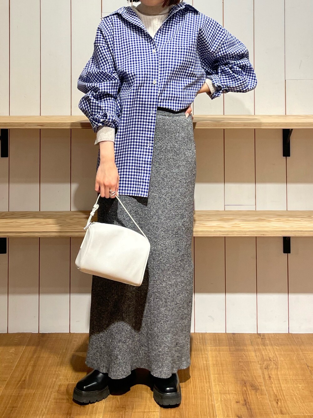ホワイト系のハンドバッグ、ブルー系のシャツ/ブラウス、グレー系のスカートを着用したレディースの冬コーディネートの2枚目の写真