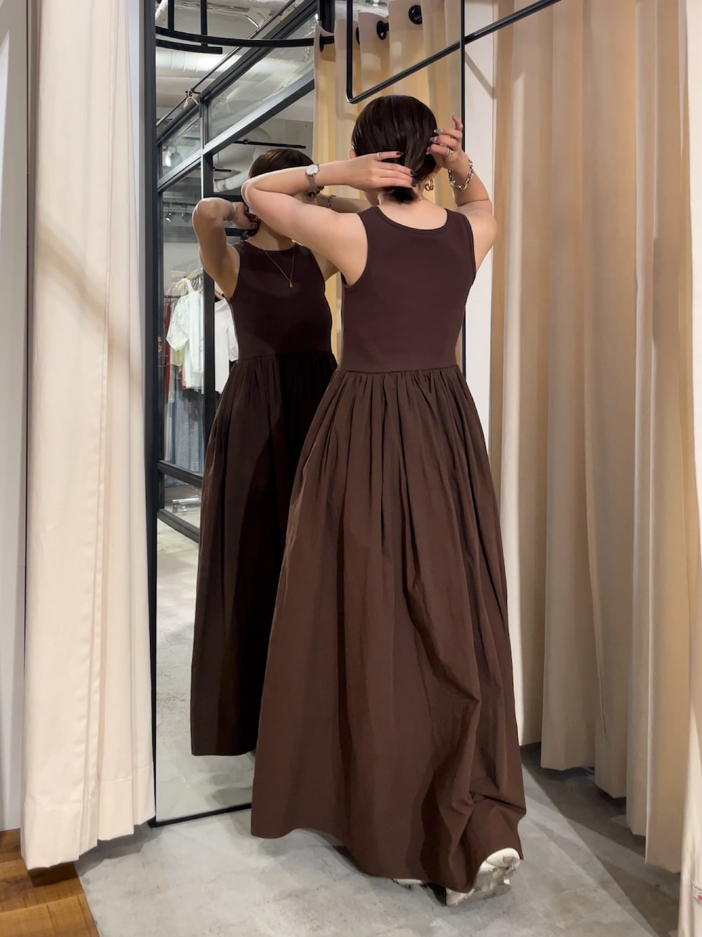 ホワイト系のキャミソール、ブラウン系のワンピース、ゴールド系のネックレスを着用したレディースの春コーディネートの2枚目の写真