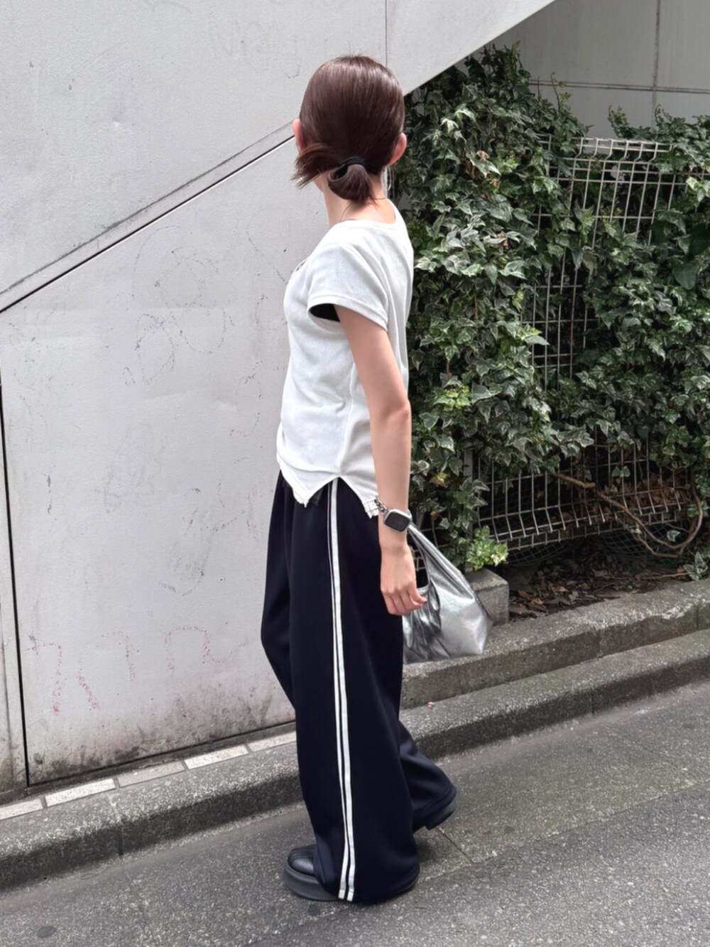 シルバー系のハンドバッグ、ブルー系のその他パンツ、ホワイト系のTシャツ/カットソーを着用したレディースの夏コーディネートの2枚目の写真