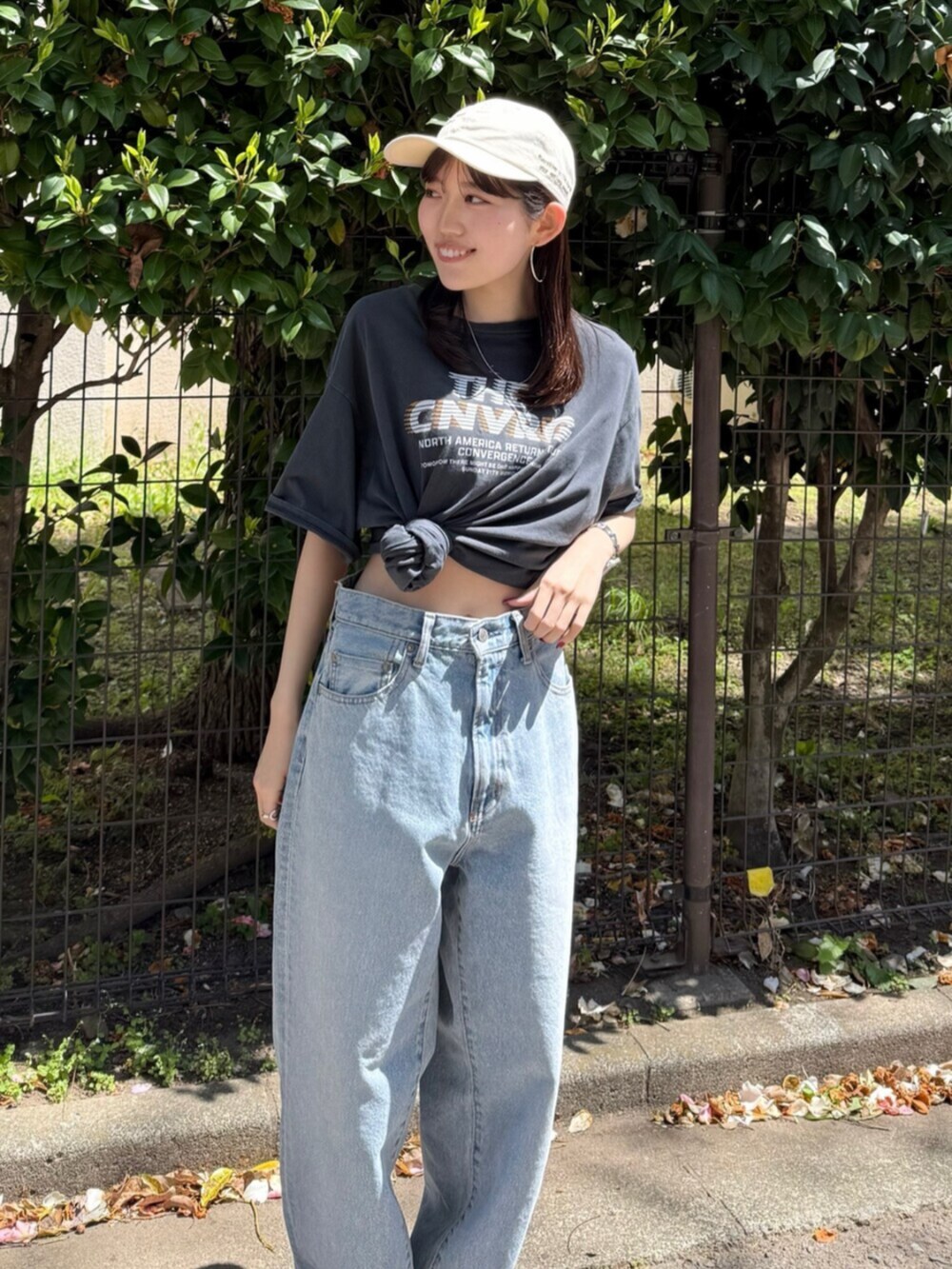 ブルー系のデニムパンツ、ブラック系のサンダル、グレー系のTシャツ/カットソーを着用したレディースの春コーディネートの2枚目の写真