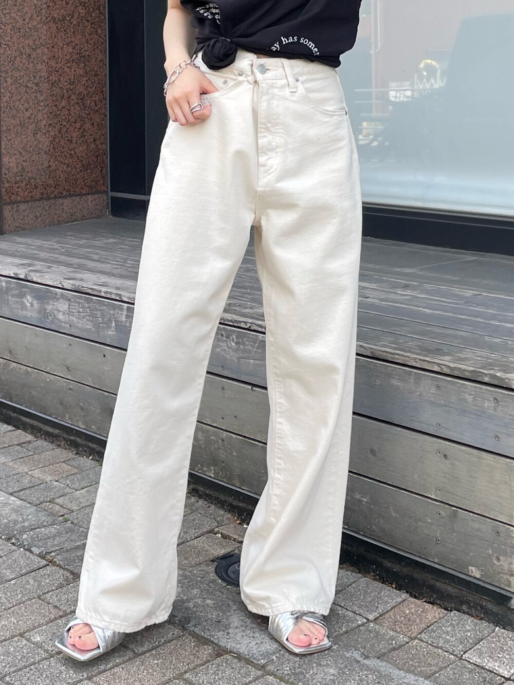 シルバー系のサンダル、ホワイト系のデニムパンツ、ブラック系のTシャツ/カットソーを着用したレディースの夏コーディネートの6枚目の写真