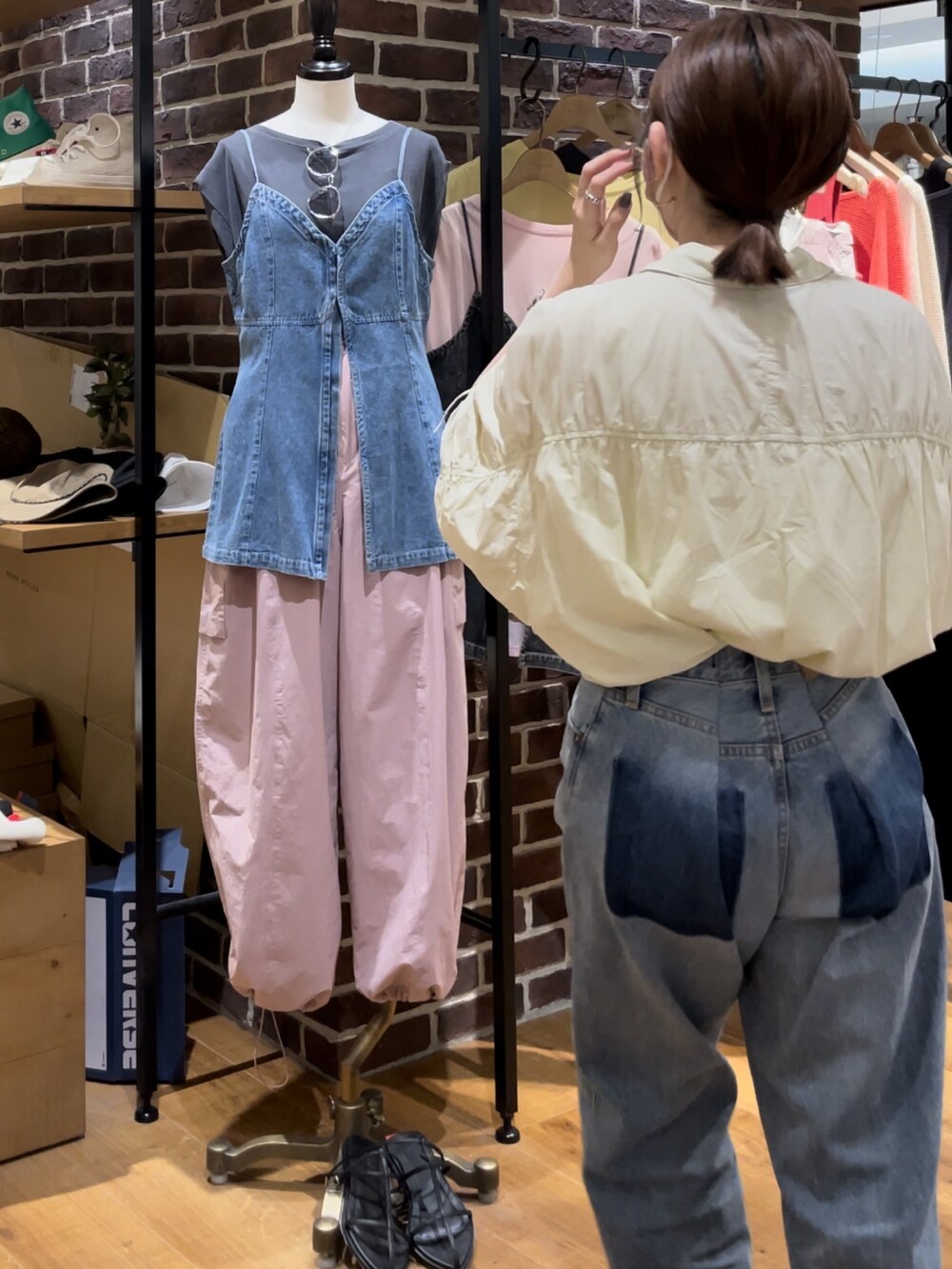 イエロー系のシャツ/ブラウス、ブルー系のデニムパンツを着用したレディースの夏コーディネートの4枚目の写真