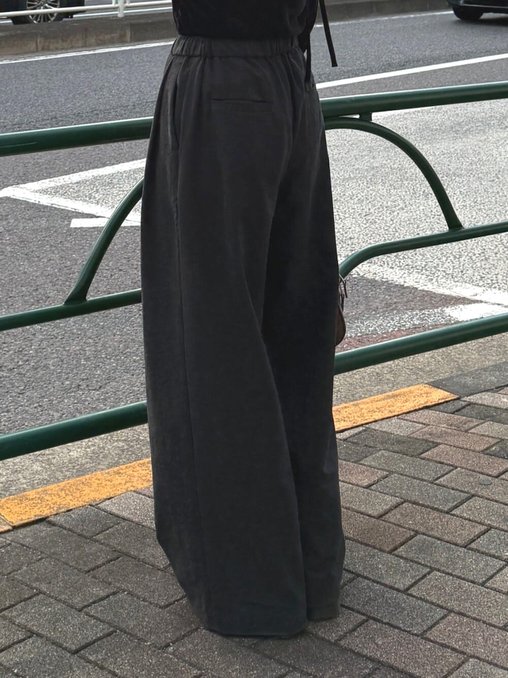 ブラウン系のハンドバッグ、グレー系のその他パンツ、ブラック系のTシャツ/カットソーを着用したレディースの秋コーディネートの7枚目の写真