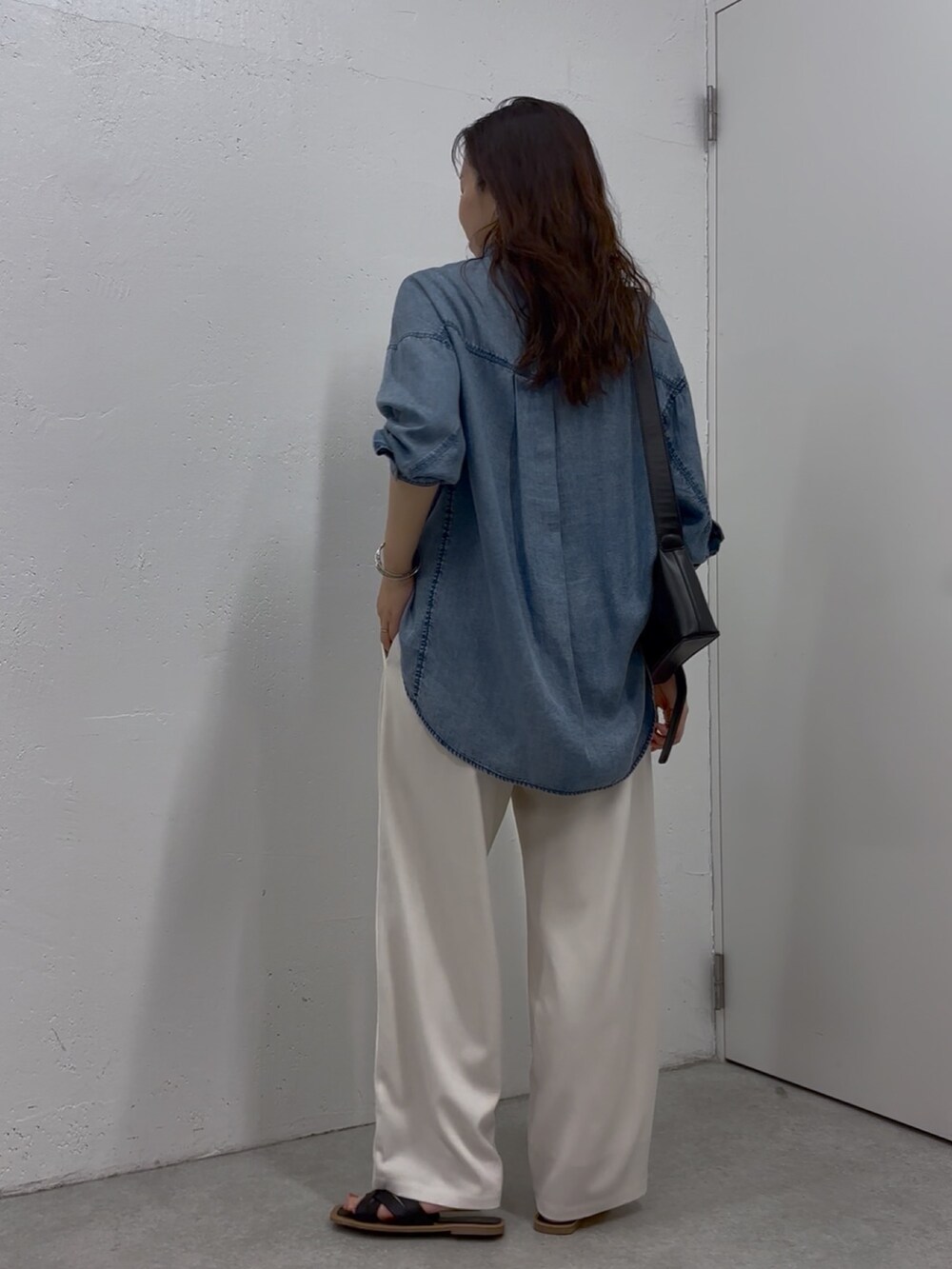 ブルー系のシャツ/ブラウス、ホワイト系のその他パンツ、ブラック系のショルダーバッグを着用したレディースの春コーディネートの4枚目の写真