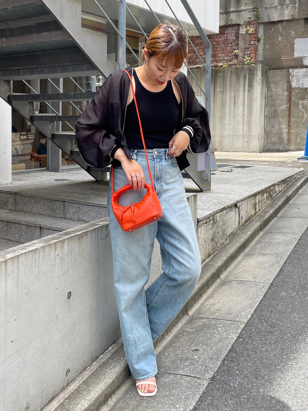 ブラック系のブルゾンを着用したレディースの夏コーディネートの2枚目の写真