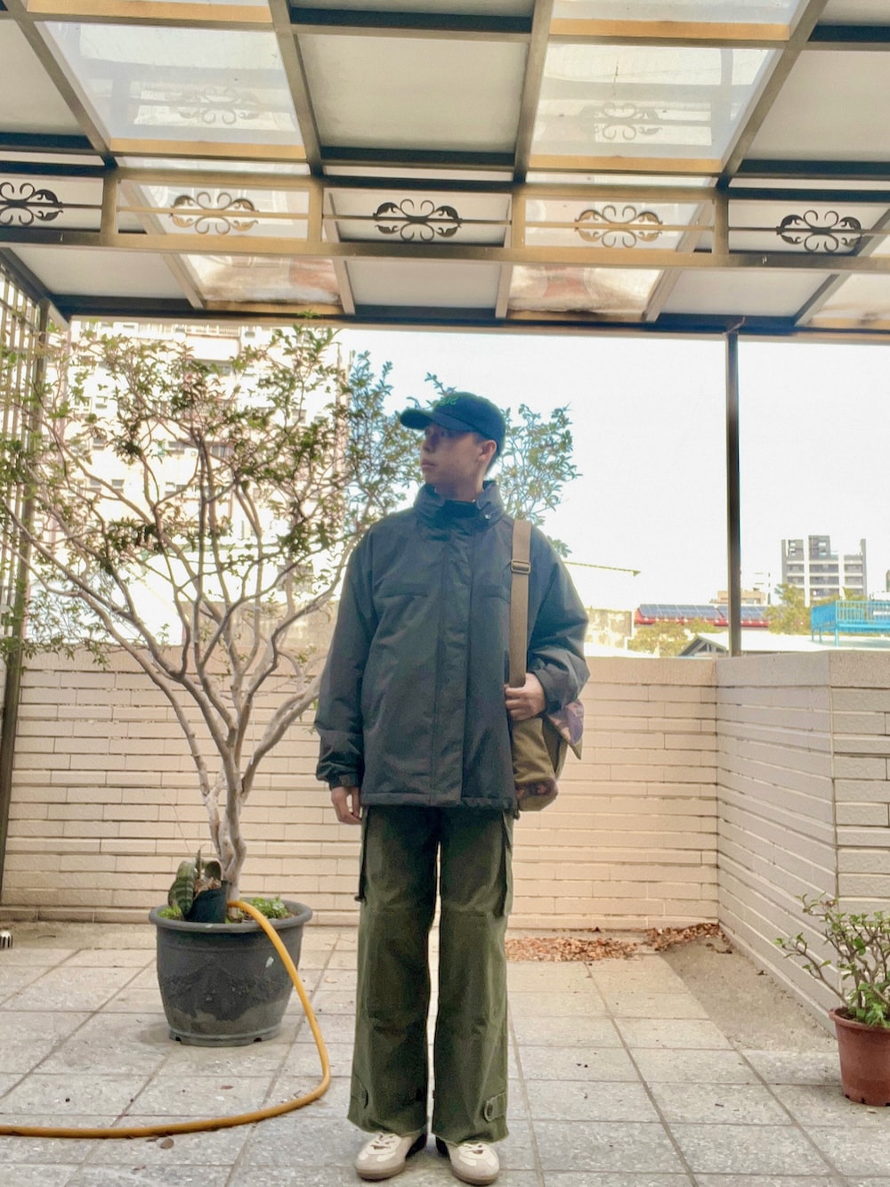 グレー系のミリタリージャケット、グレー系のジャージ、グリーン系のカーゴパンツを着用したメンズの冬コーディネートの3枚目の写真