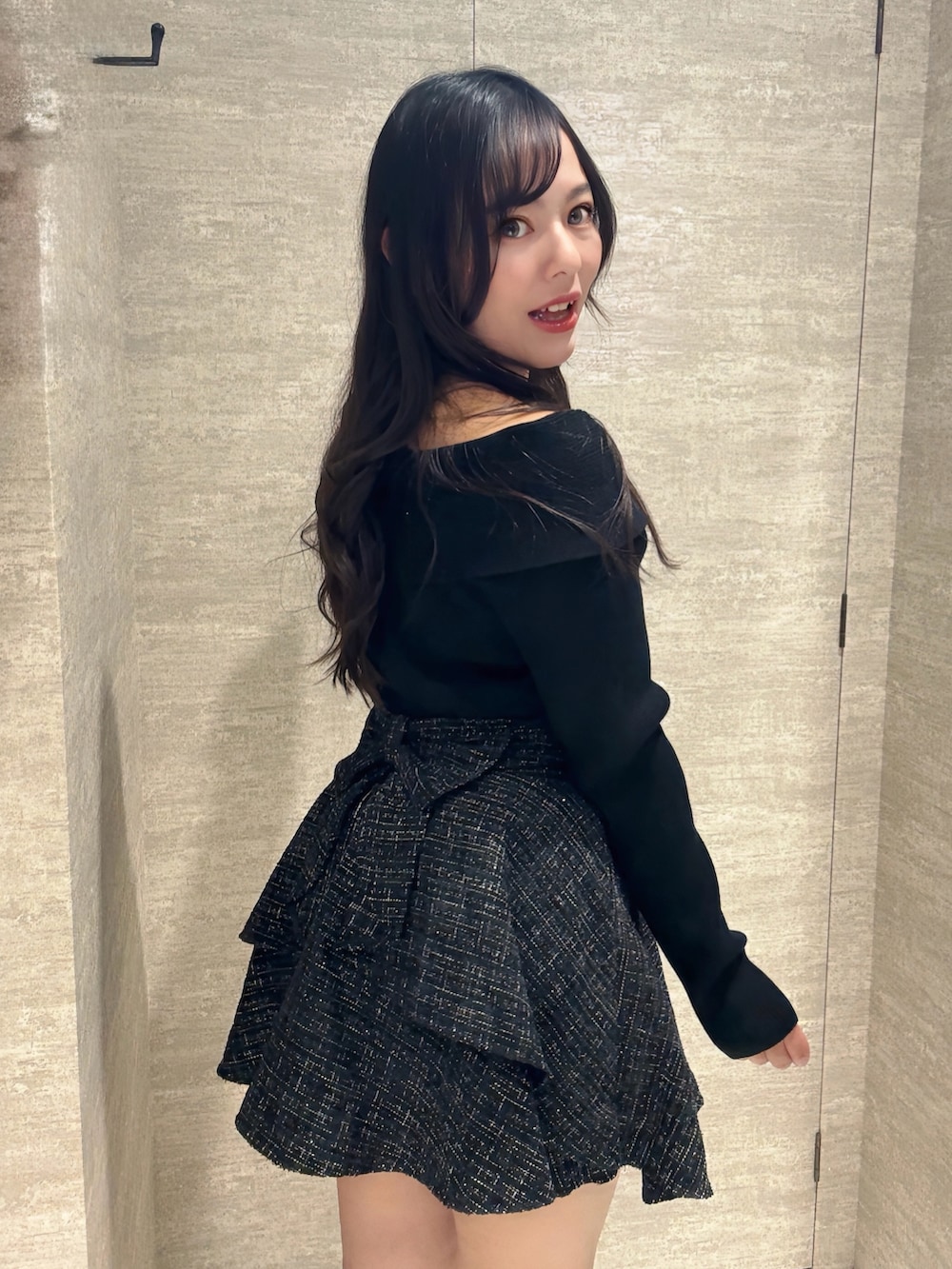 ブラック系のスカート、ブラック系のニット/セーターを着用したレディースの秋コーディネートの2枚目の写真