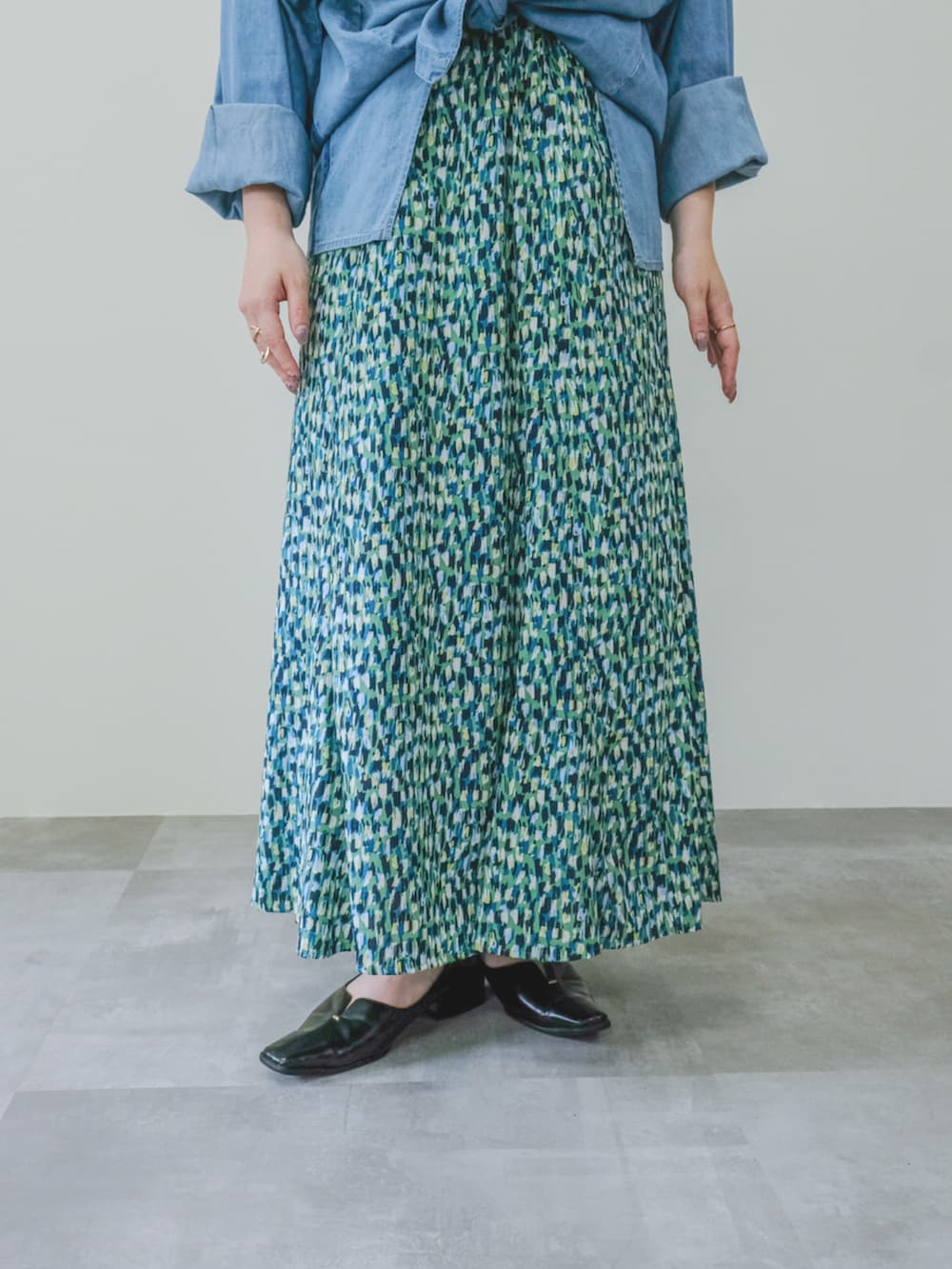 グリーン系のスカートを着用したレディースの夏コーディネートの2枚目の写真